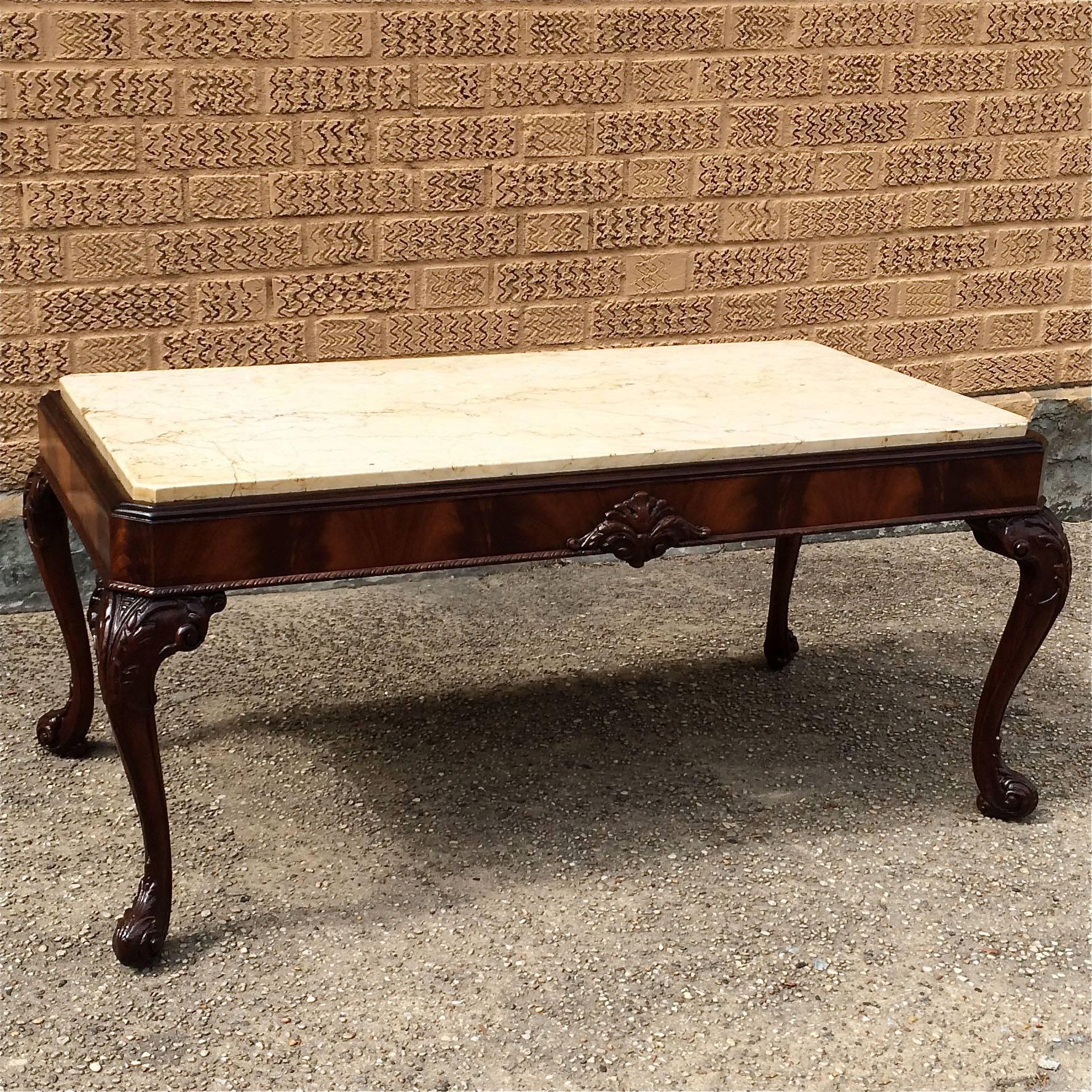 Antique, carved, flame mahogany coffee table with marble top and cabriole legs. Frame is newly restored and marble is original.