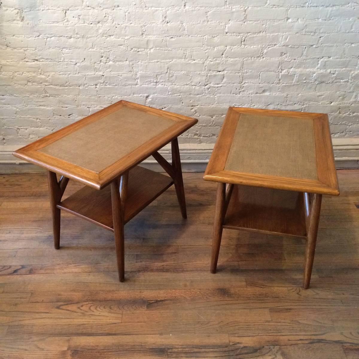 Pair of two-tiered, oak end tables with woven grass cloth top and rounded edges attributed to Paul Laszlo.