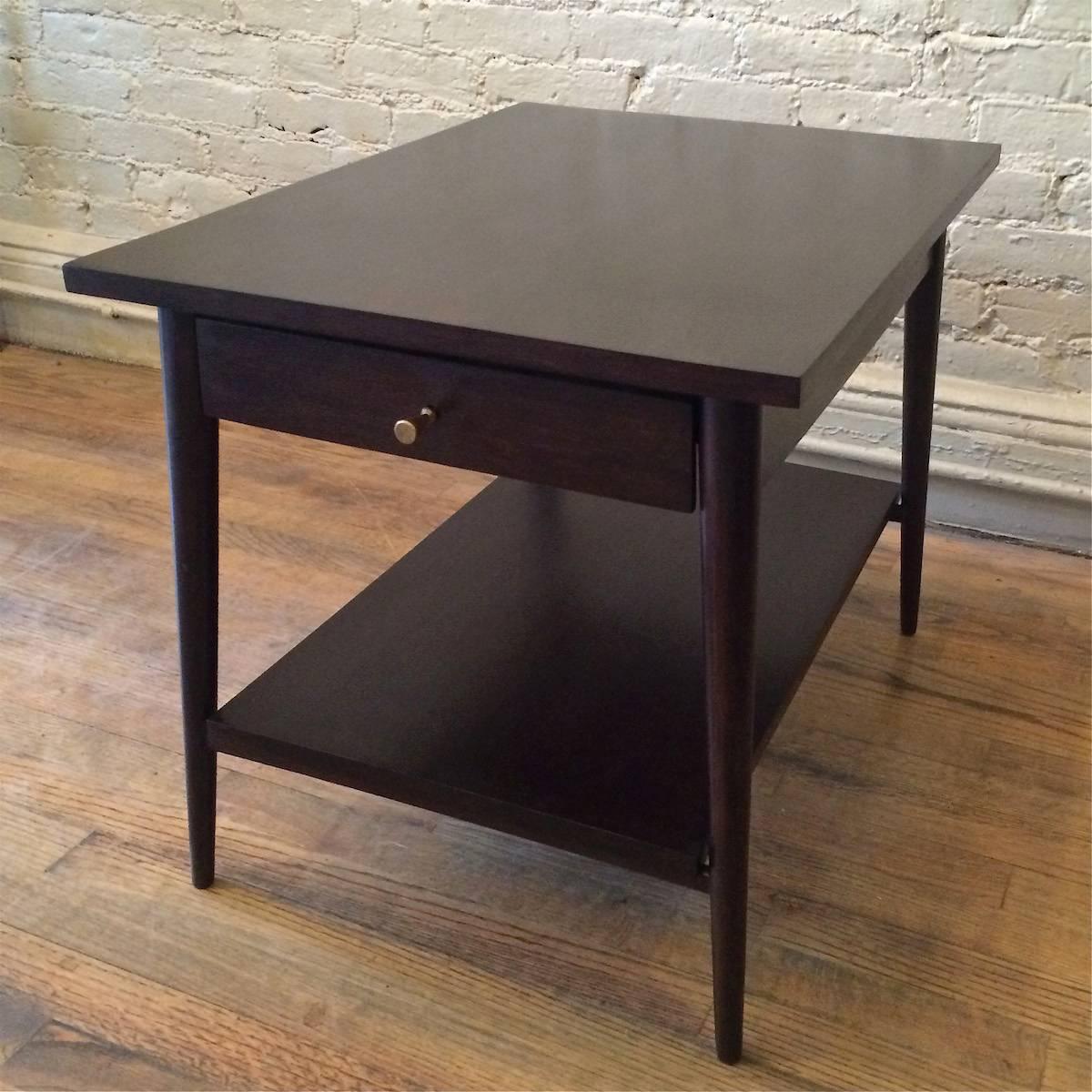 End table with drawer by Paul McCobb for Planner Group, manufactured by Winchendon, with signature hourglass brass pull in an ebonized finish.