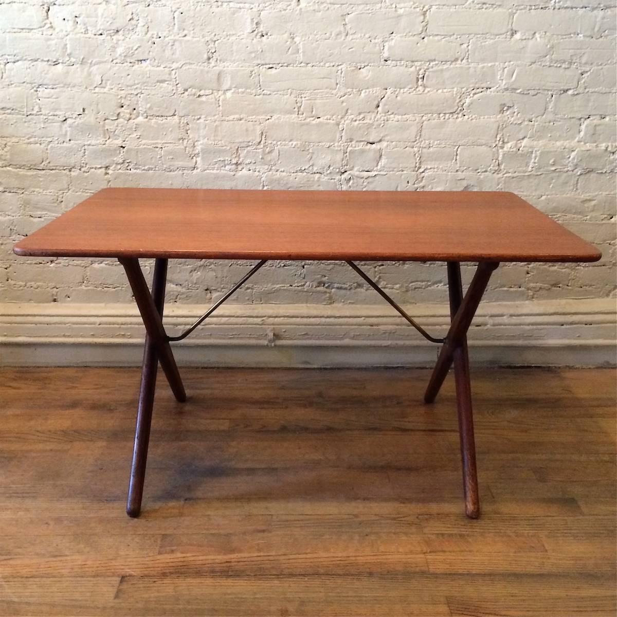 Danish modern, occasional, side or end table by Hans Wegner for Andreas Tuck with brass stretchers, teak top and oak legs.