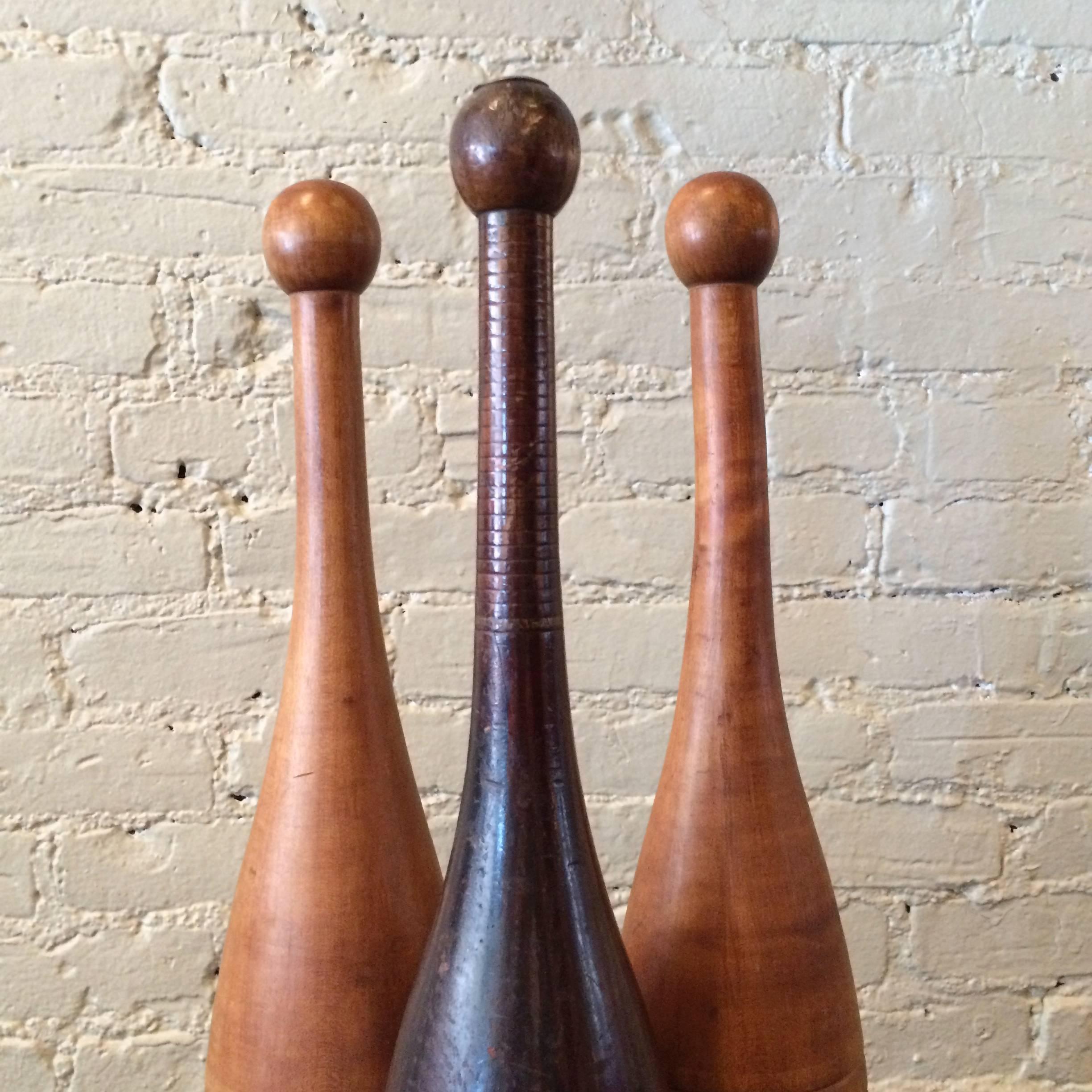 Late 19th century, hand-turned, maple juggling pins or weights are striking decorative objects.