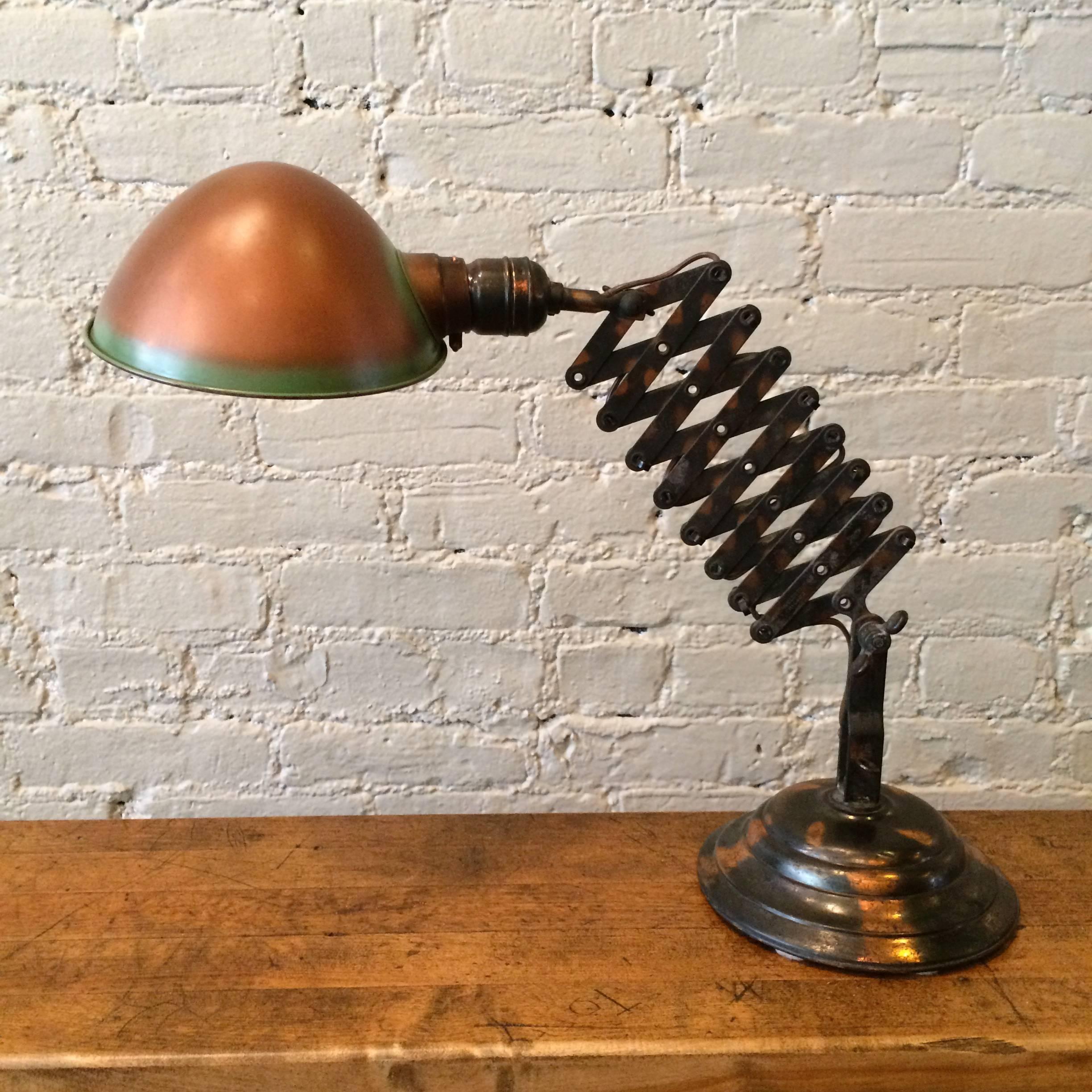 Rare, Industrial, Faries, copper oxide (japanned), extending scissor lamp, circa 1918 that articulates at the base and shade.

Measures: Base is 7