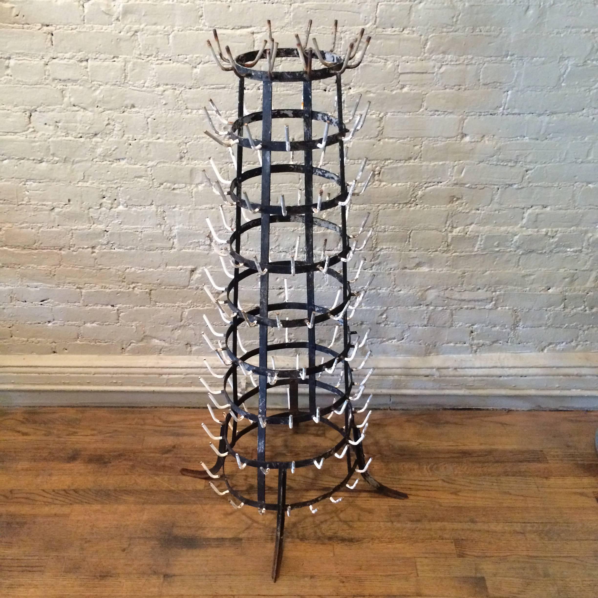 Wrought iron bottle drying rack from a dairy farm circa 1940s with original patina.

Overall diameter with feet is 25