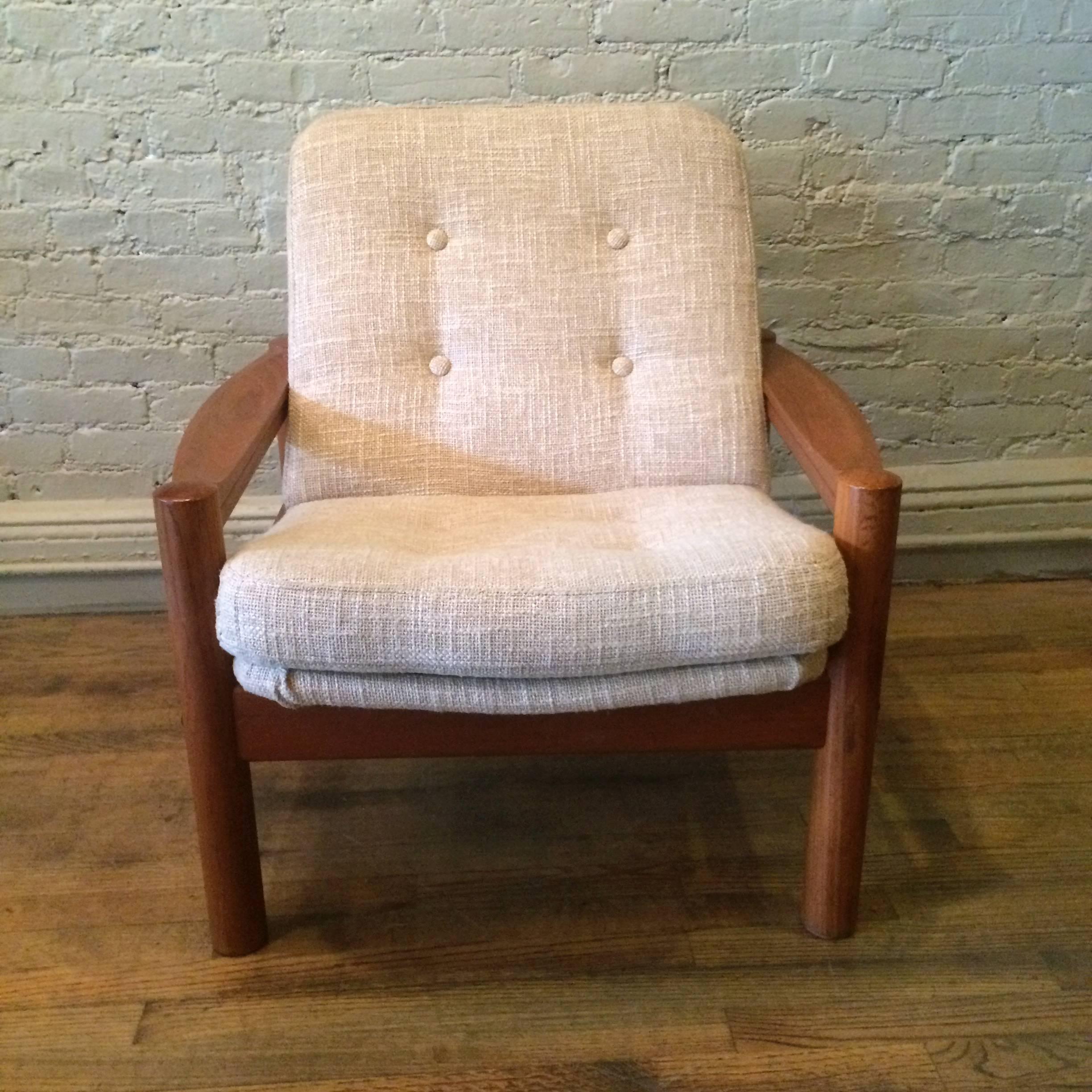 Danish Modern, teak lounge chair by Domino Mobler Denmark is newly upholstered in an oatmeal linen blend. 