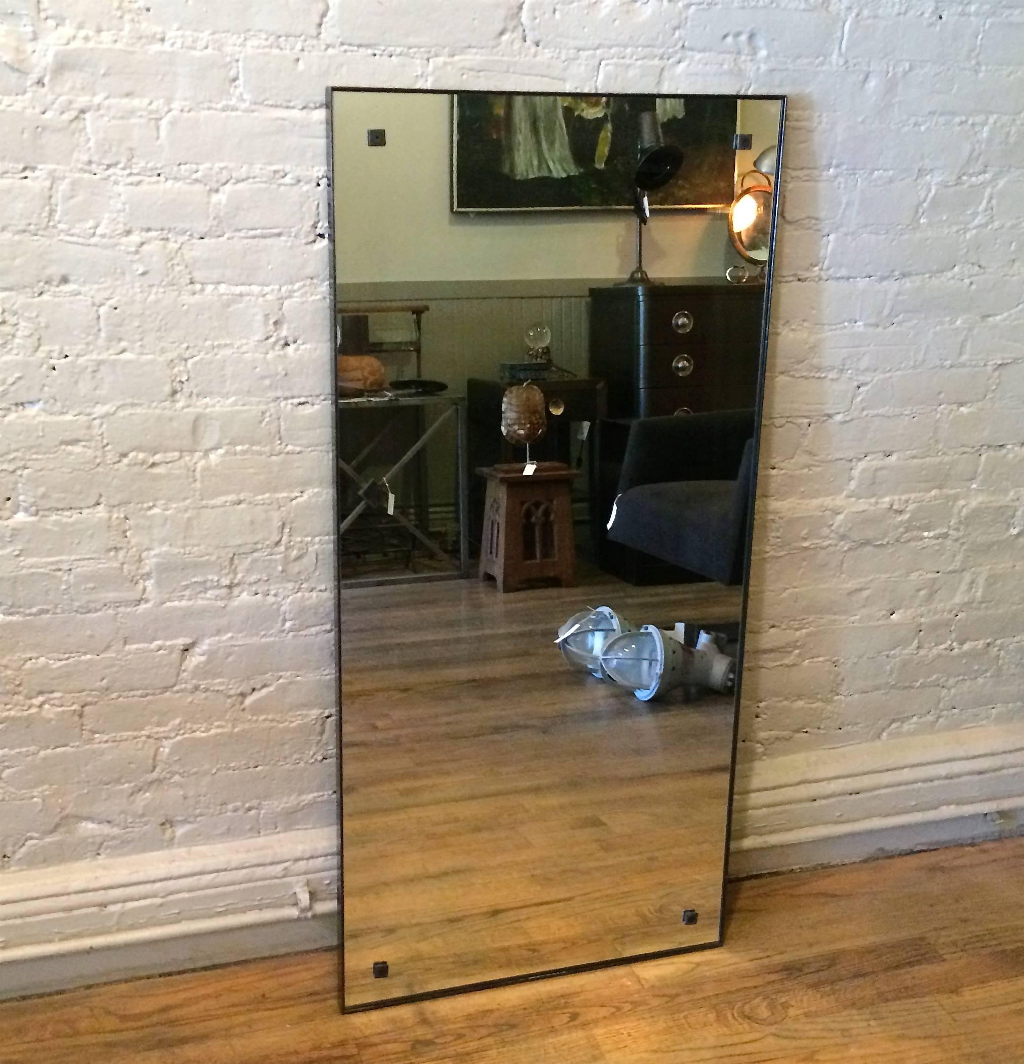 Industrial, blackened-steel framed mirror with square metal details in each corner.