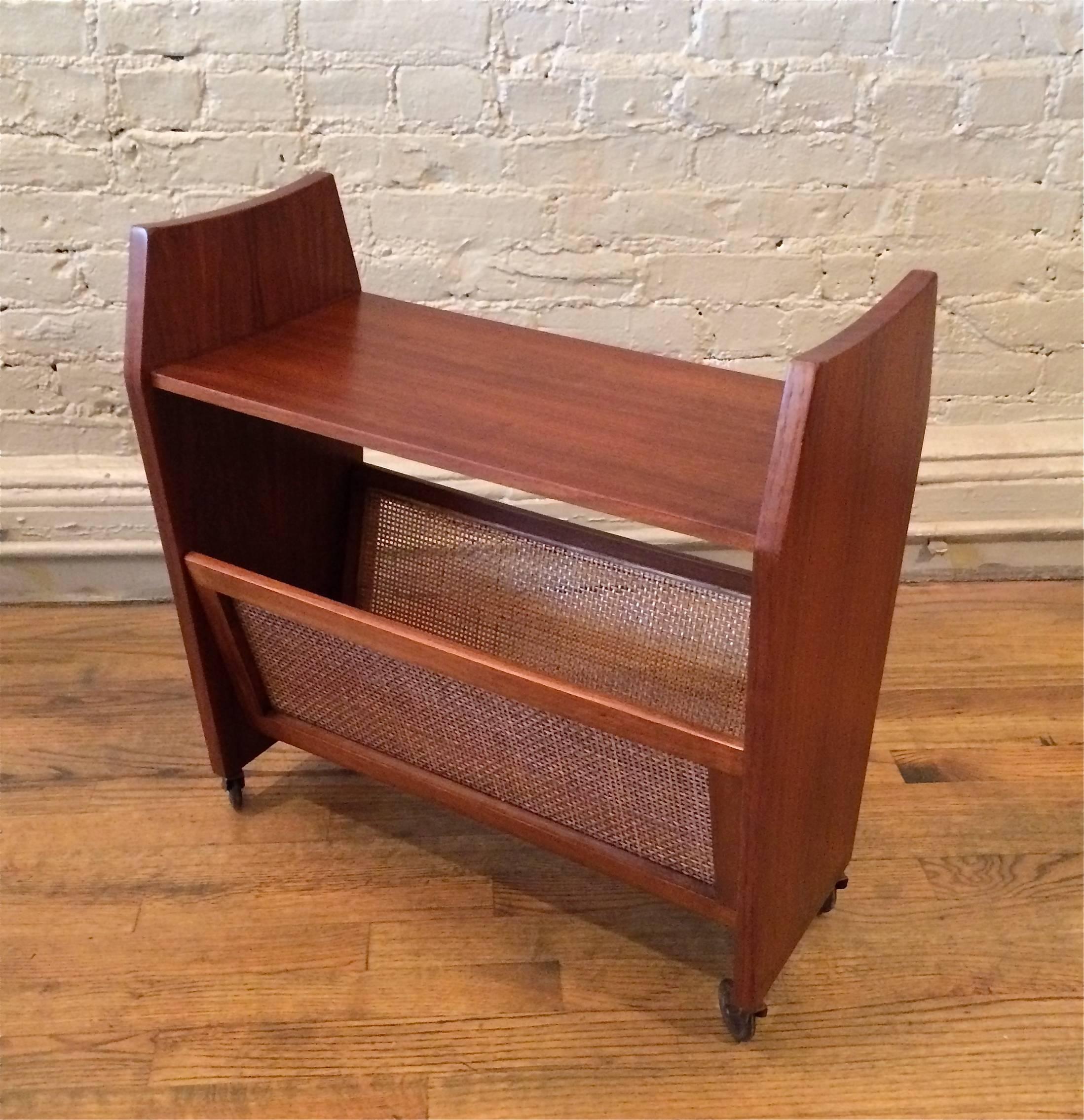 Danish modern, rolling, teak, magazine rack side table with caned sides.