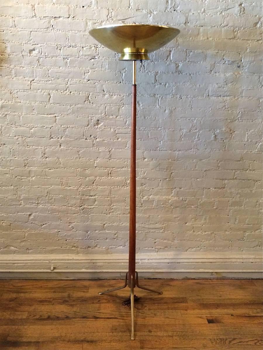 Mid-Century Modern, uplighting, torchiere floor lamp by Gerald Thurston for Lightolier features a walnut stem, brass accents and perforated brass shade.