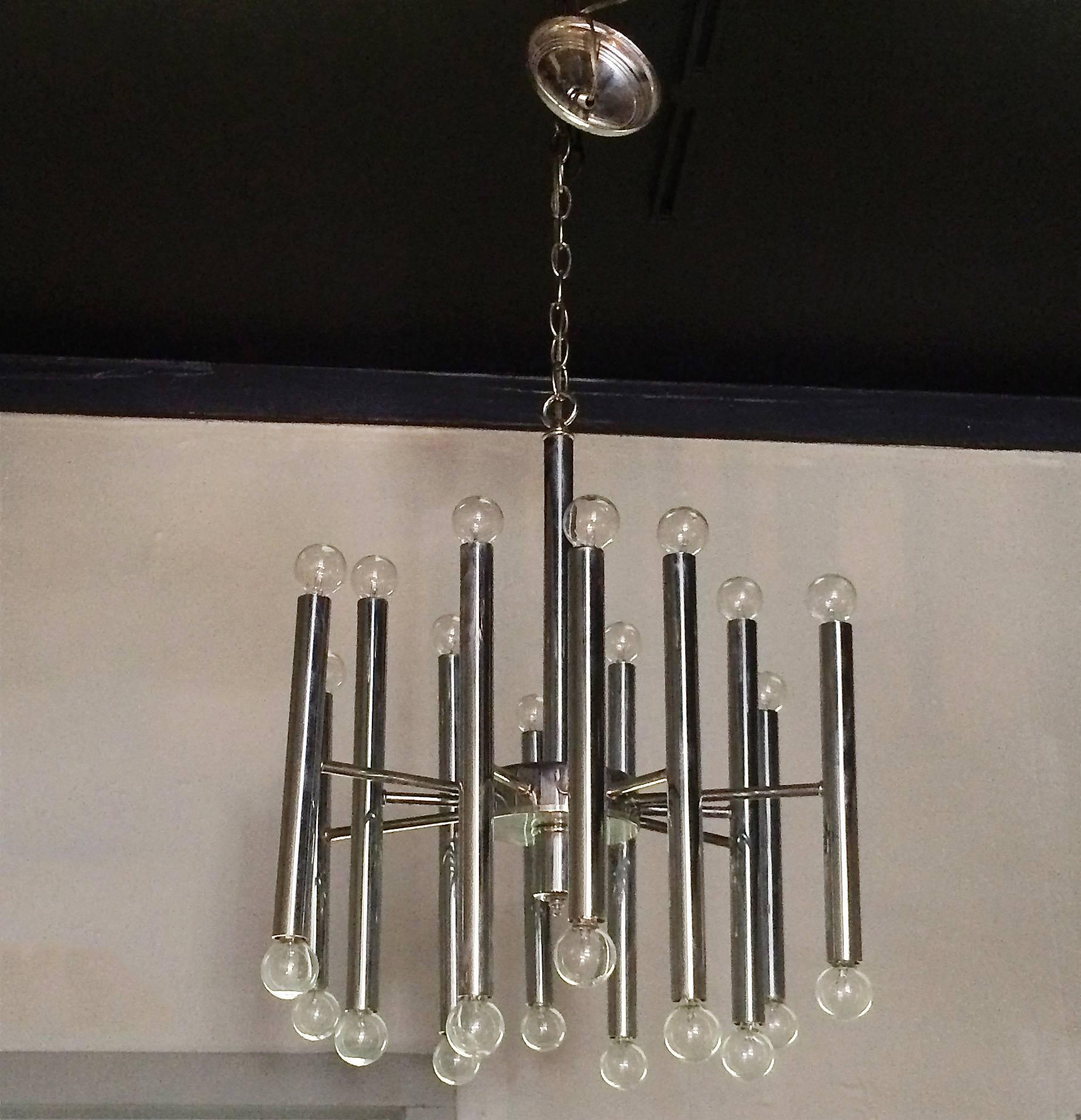 Mid-Century Modern, 1960s, tubular chrome chandelier with 12 arms that light on each end for a total of 24 candelabra bulbs in the style of Gaetano Sciolari. Matching canopy included.
