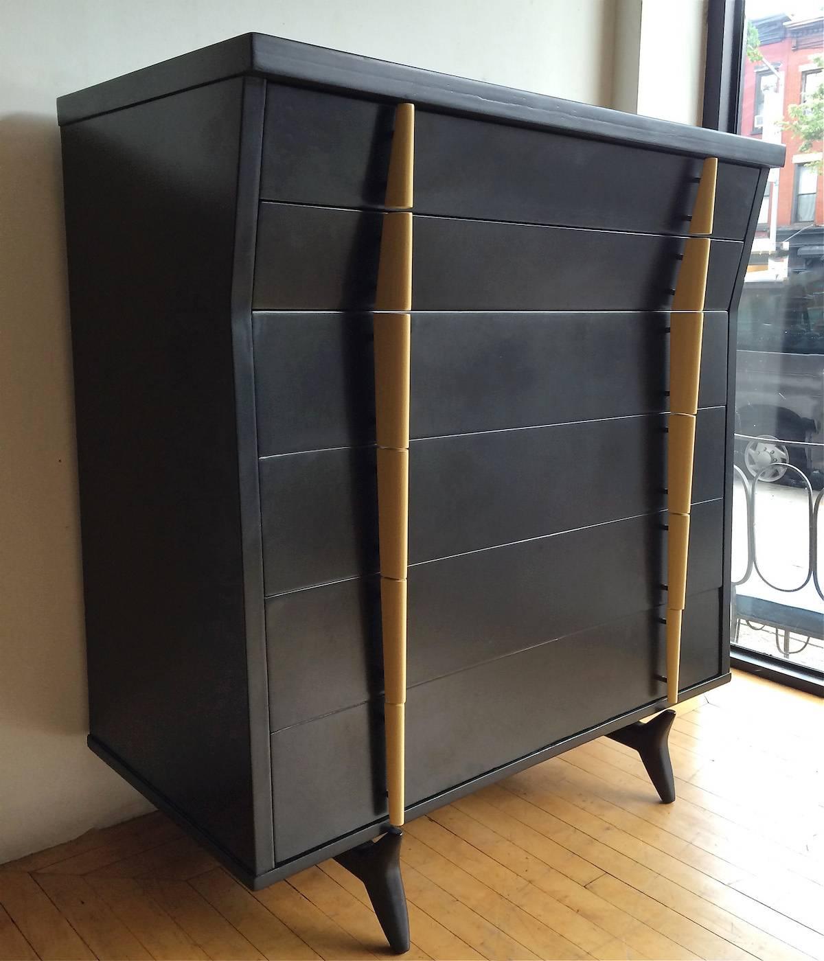 Mid-Century Modern, mahogany highboy dresser is lacquered black with contrasting ivory colored lacquered handles. Architectural profile and sculpted handles and feet make this a fantastic piece.