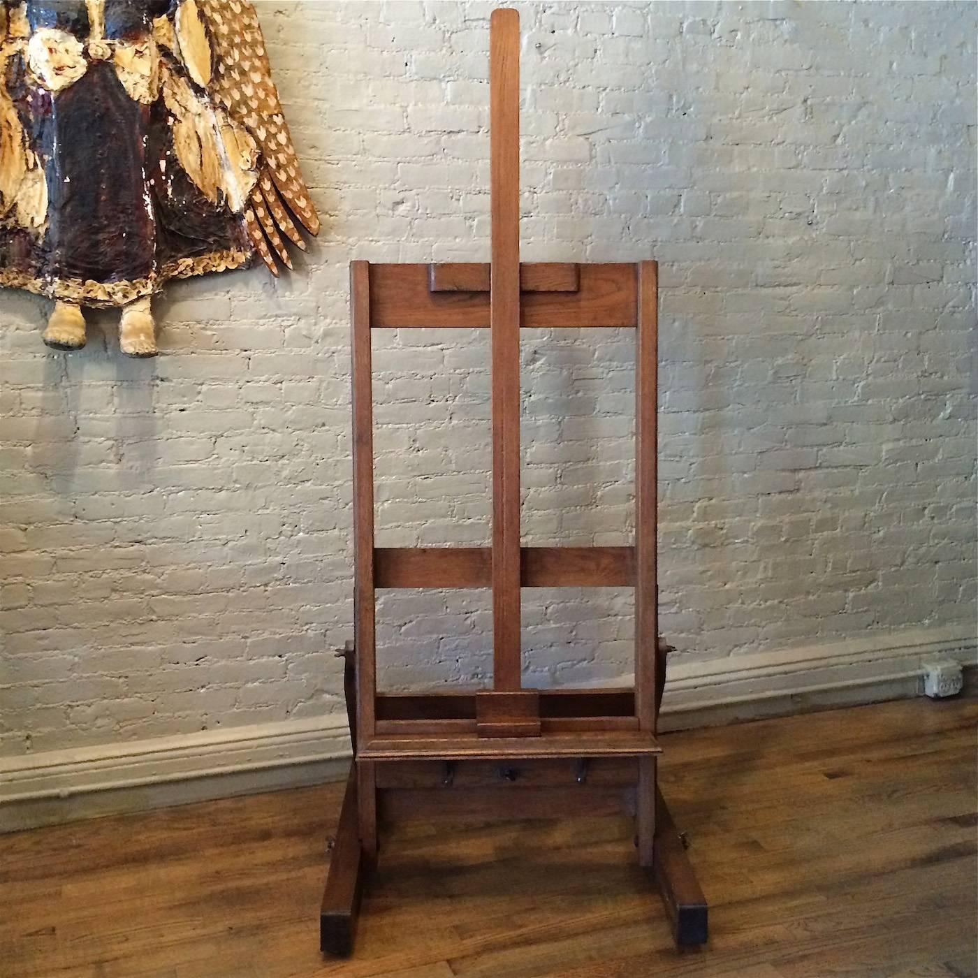 Large format, adjustable height, American Craftsman and artist easel, circa 1920s is solid oak on rolling base. Adjusting mechanisms are cast iron.