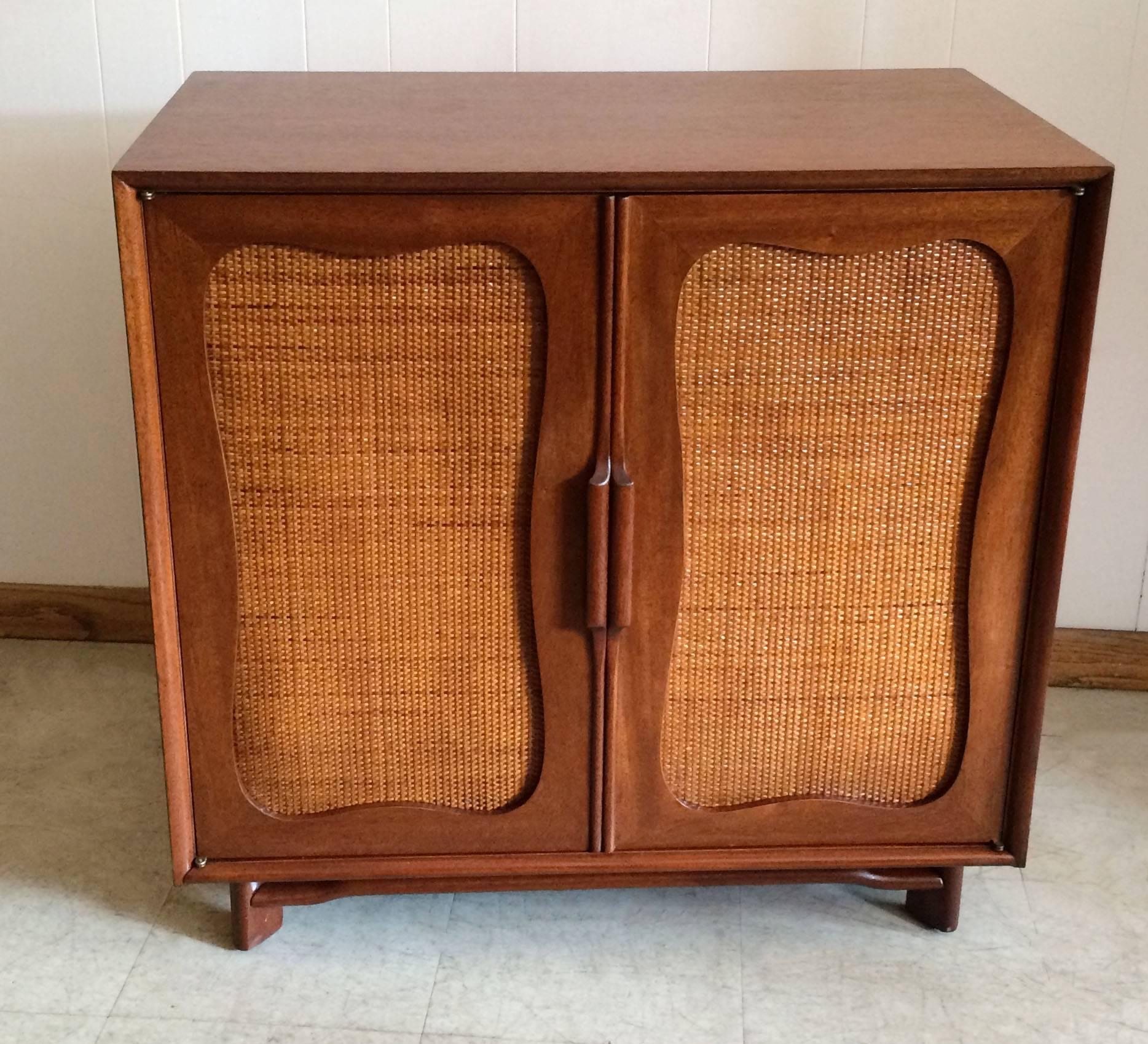 Mid-Century Modern, mahogany dresser by Hickory Furniture Company with decorative rattan doors.