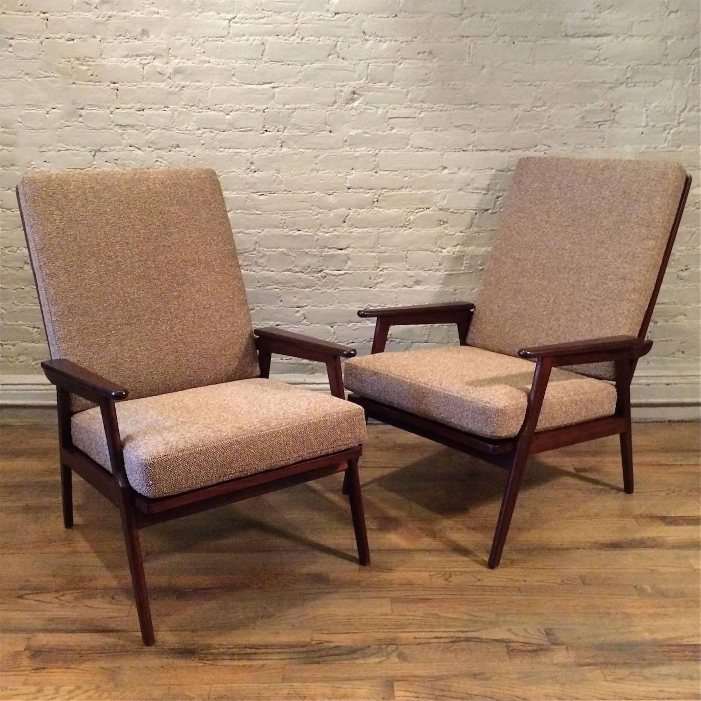 Pair of Mid-Century Modern, high back, stained beech, lounge chairs marked Made in Italy are newly upholstered in a nubby mocha tweed.