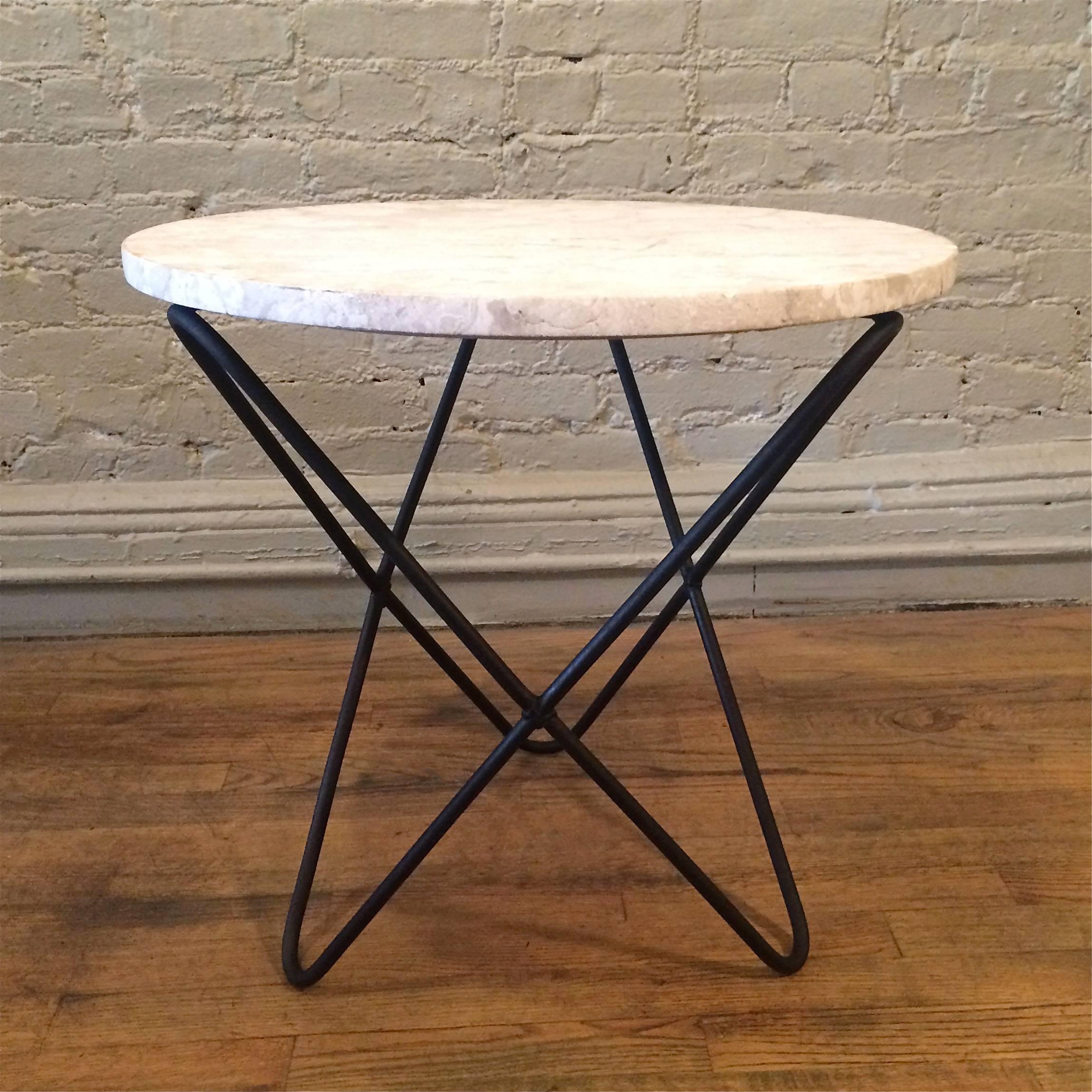 Rare, elegant side table with round, unpolished, travertine top and painted wrought iron, butterfly base in the manner of Jorge Ferrari Hardoy.