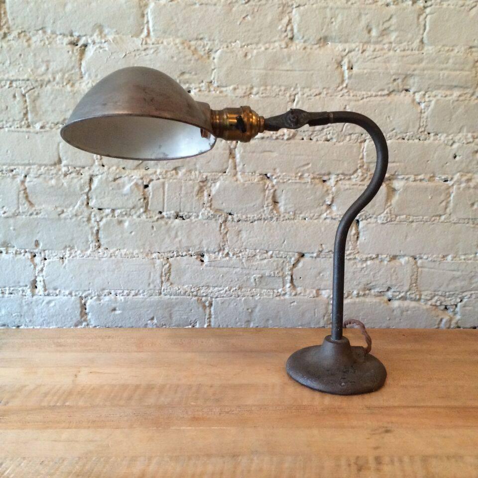 Late 19th century, train station lamp by O.C. White with cast iron base, steel stem, brushed steel shade and brass fitter. The lamp is newly wired for up to 200 watt bulbs.