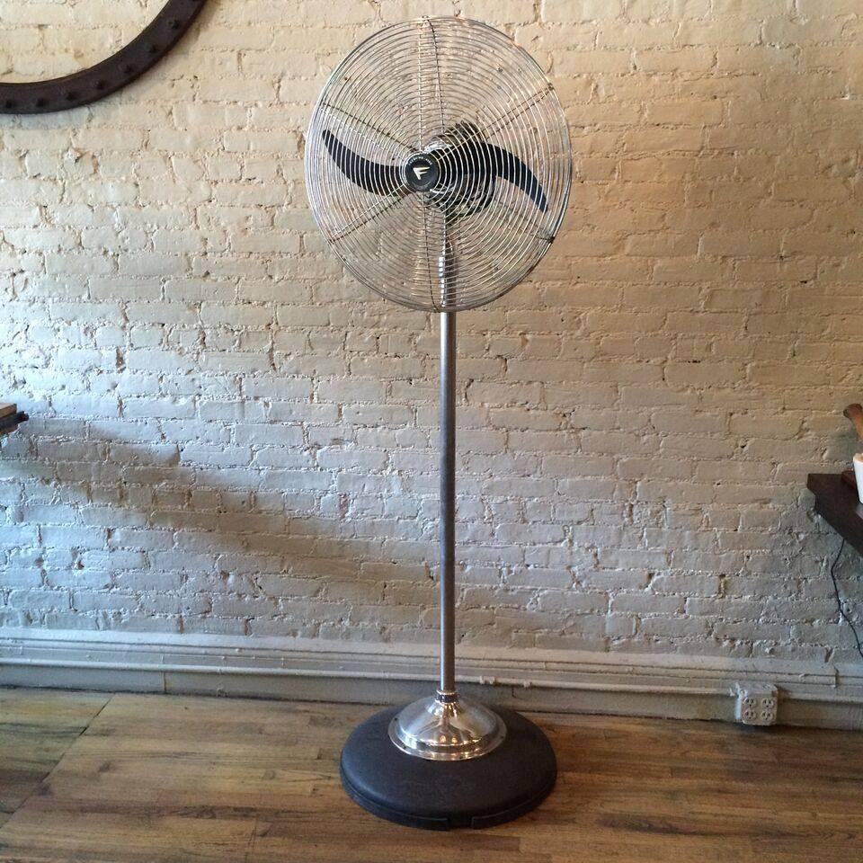 Large, Mid-Century, industrial, Fresh'nd-Aire standing floor fan with chrome-plated frame and shaft and weighed cast iron base has an airplane blade and pull chain mechanism with two speeds.