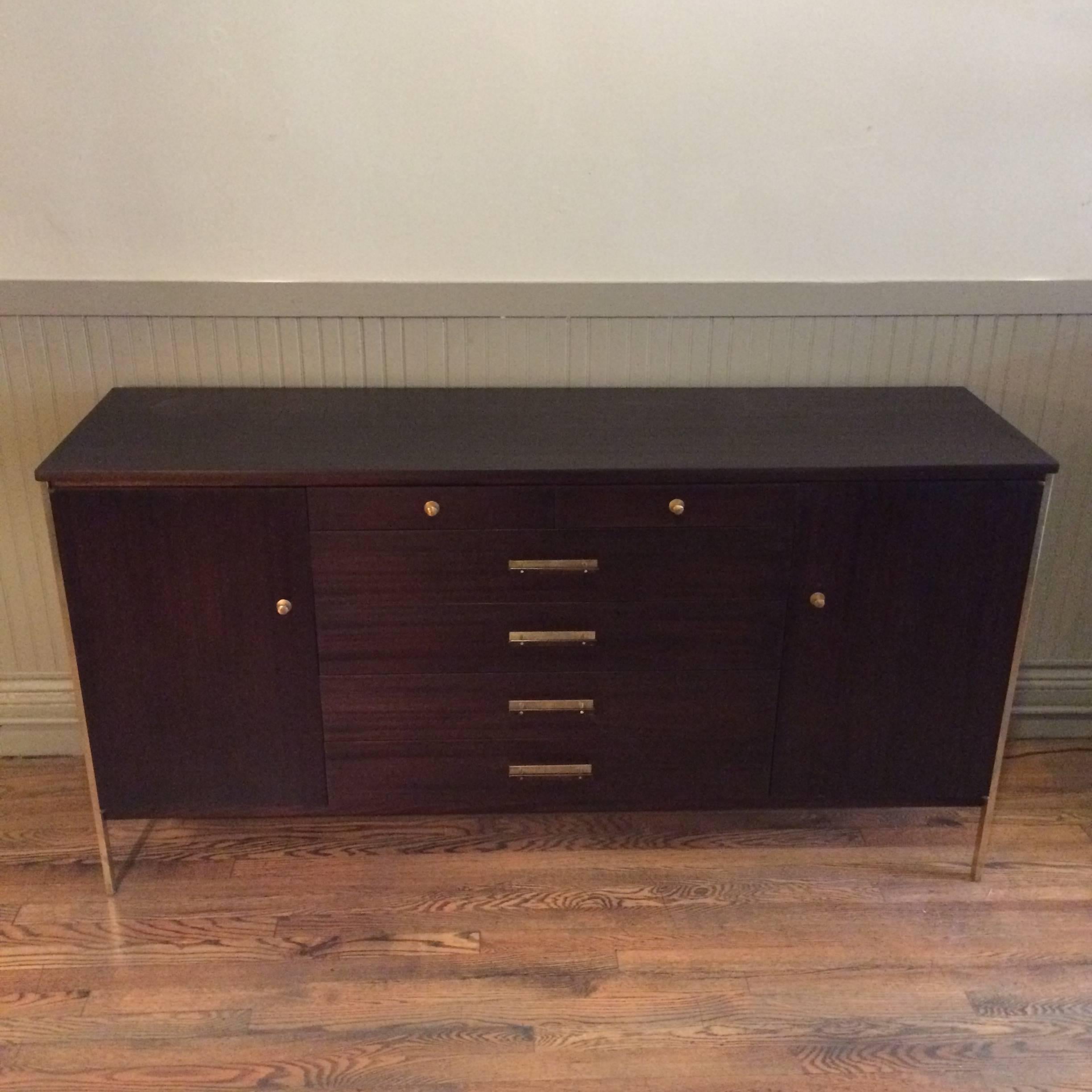 Mid-Century Modern, ebonized mahogany credenza with signature brass accents designed by Paul McCobb for The Calvin Group is newly restored.