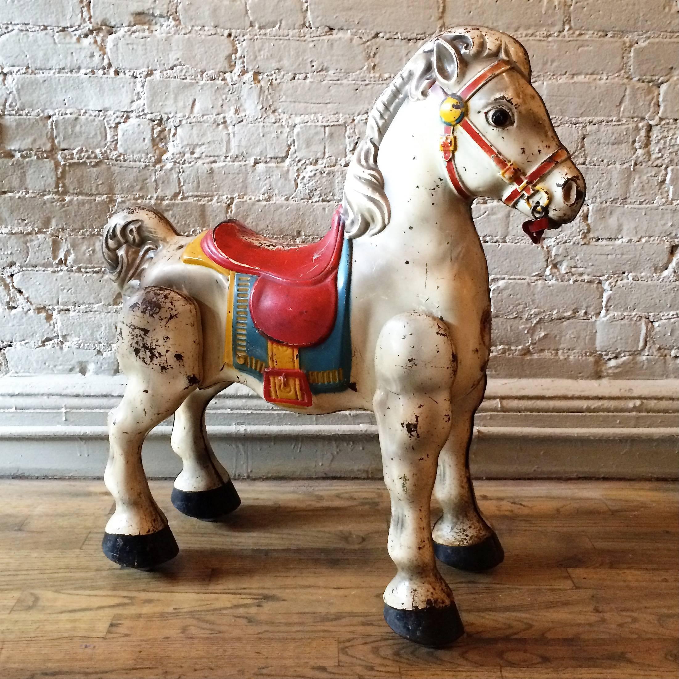 Vintage, 1940s, painted, pressed steel hobby horse manufactured by Mobo Toys, England with casters on feet and excellent patina.
