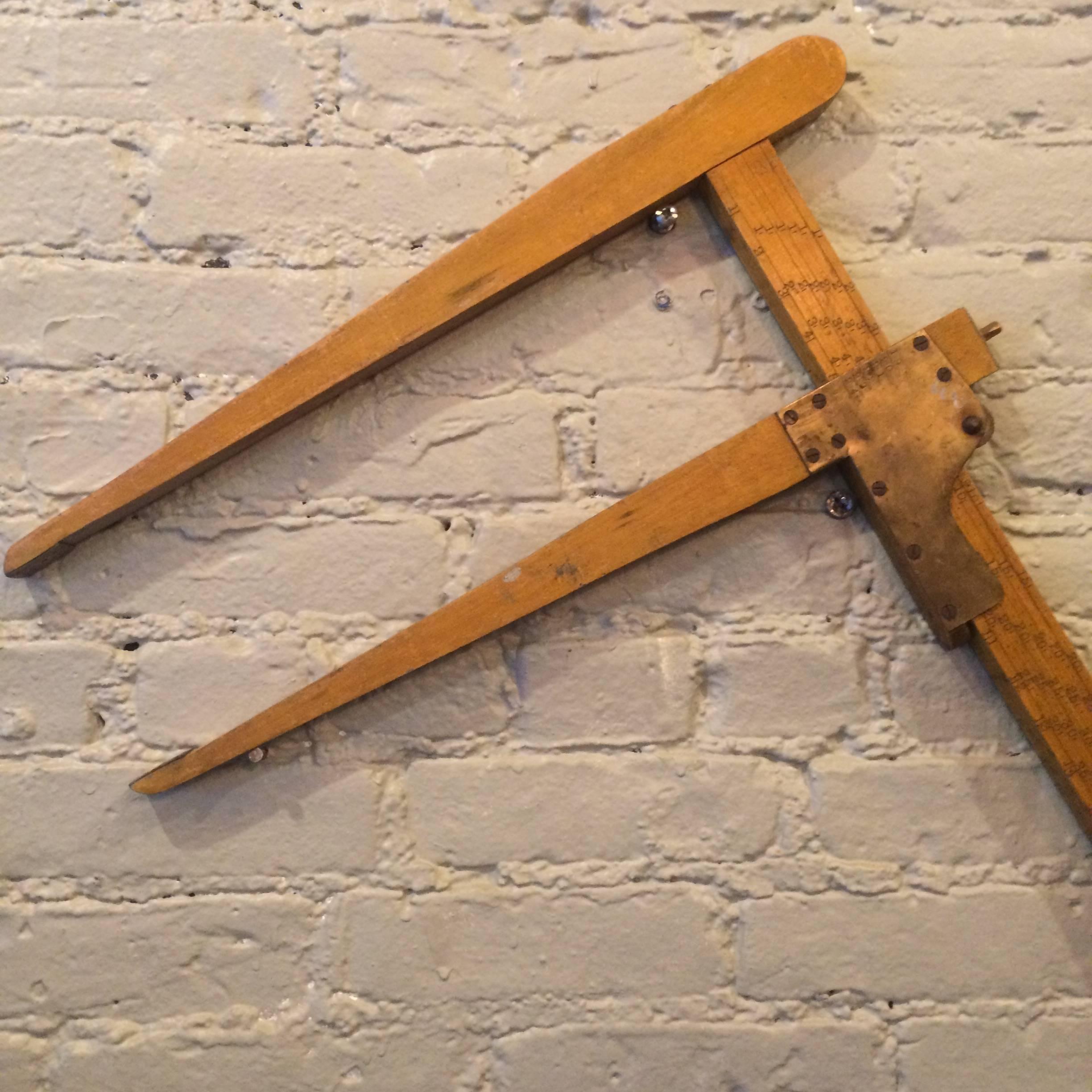 Early 20th century, wood log caliper with brass fittings.