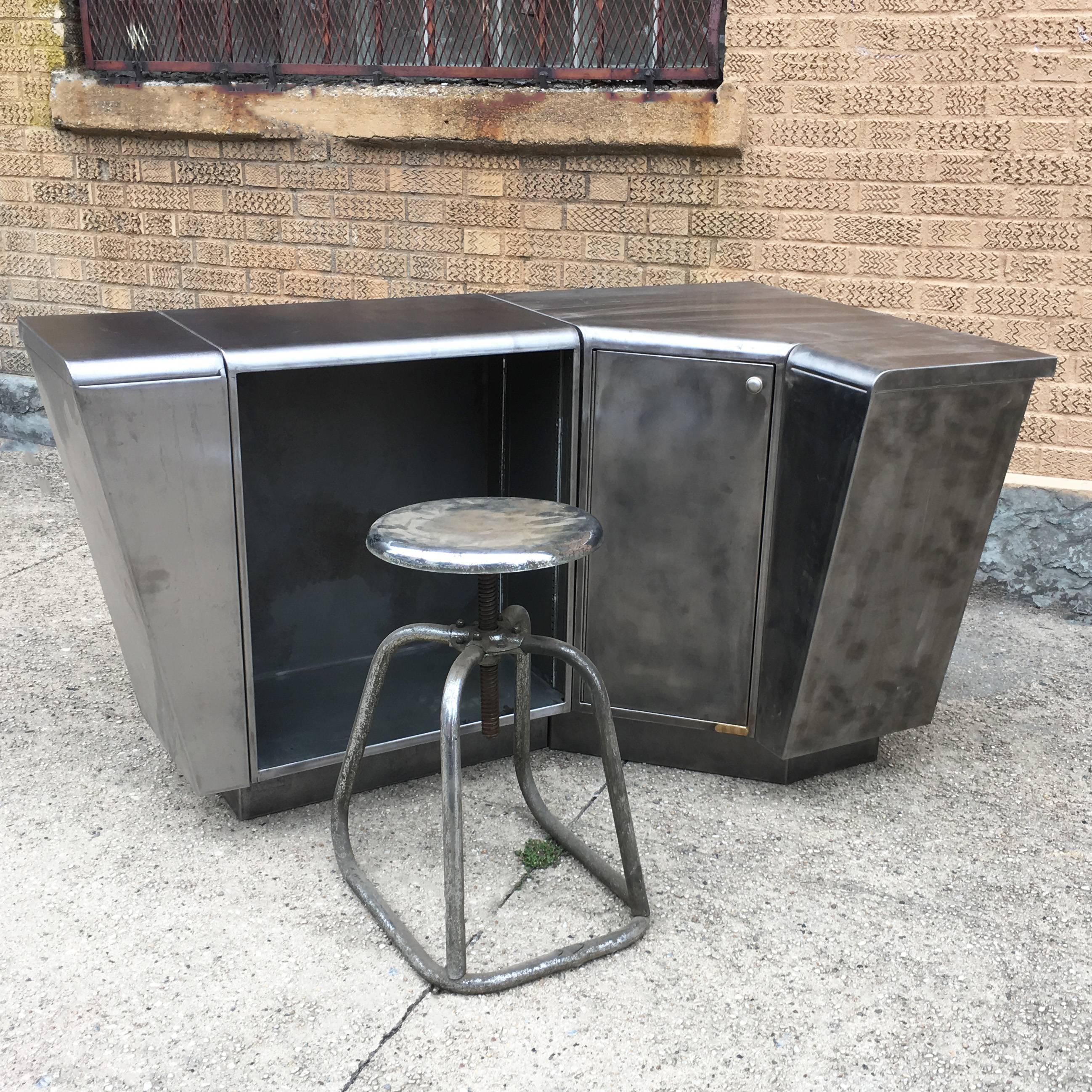 Interesting, Mid-Century, brushed steel, corner secretary, desk or station with angular lines is comprised of two sections with storage offered in the corner piece. Brushed steel stool is sold separately.

Corner piece is 23