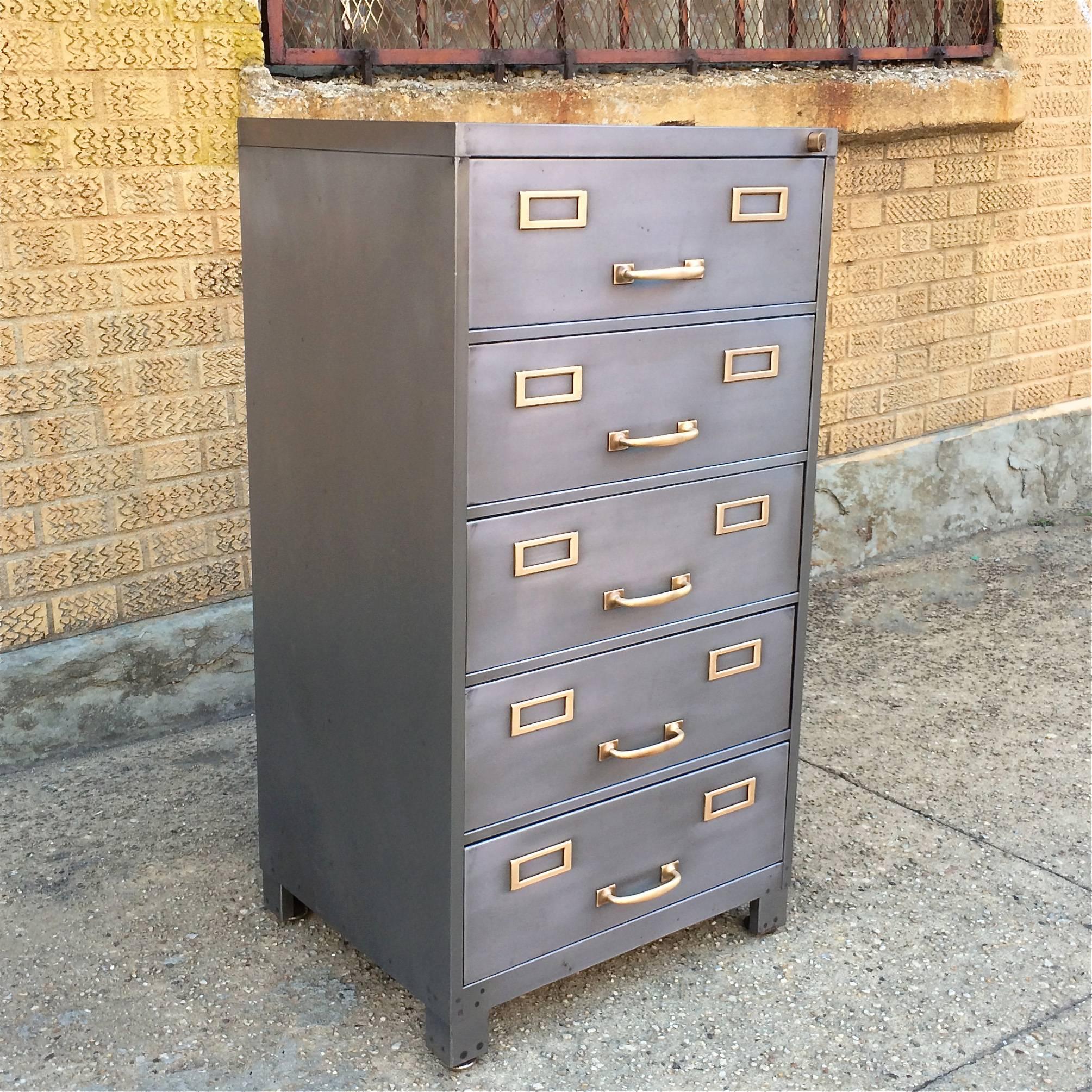 Mid-Century, hand-polished, brushed steel, 5 drawer, office, filing cabinet with polished brass hardware by Cole Steel. The cabinet is not hanging file folder cabinets.

Drawers measure 17.25" w x 5" ht x 16" d