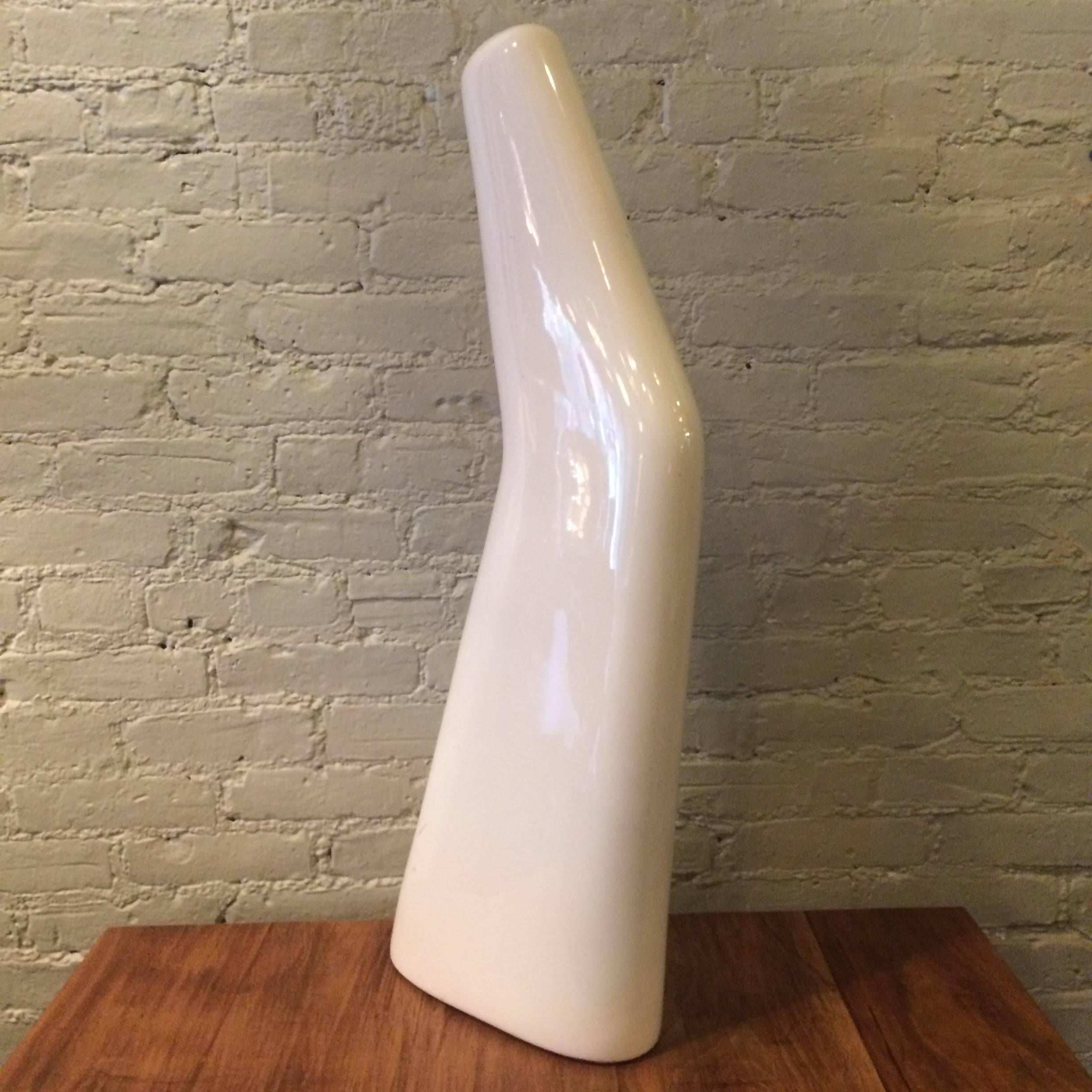 Tall, arched, porcelain, stocking display mold makes a striking, abstract, Industrial sculpture, object or accent piece.