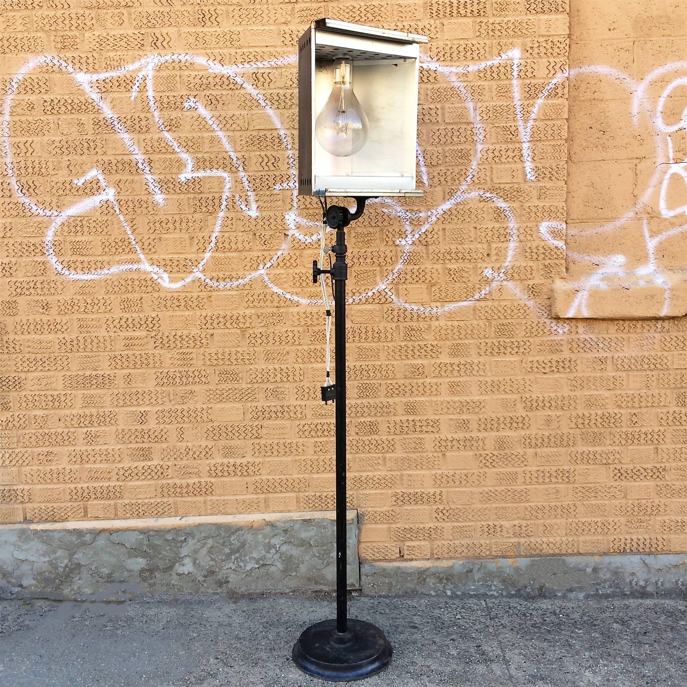 Industrial, theatre, stage light, floor lamp by Capitol Theatre Entertainment Co with cast iron base, steel stem and aluminum housing is height adjustable and uses a large format mogul bulb that can be adapted for medium socket.