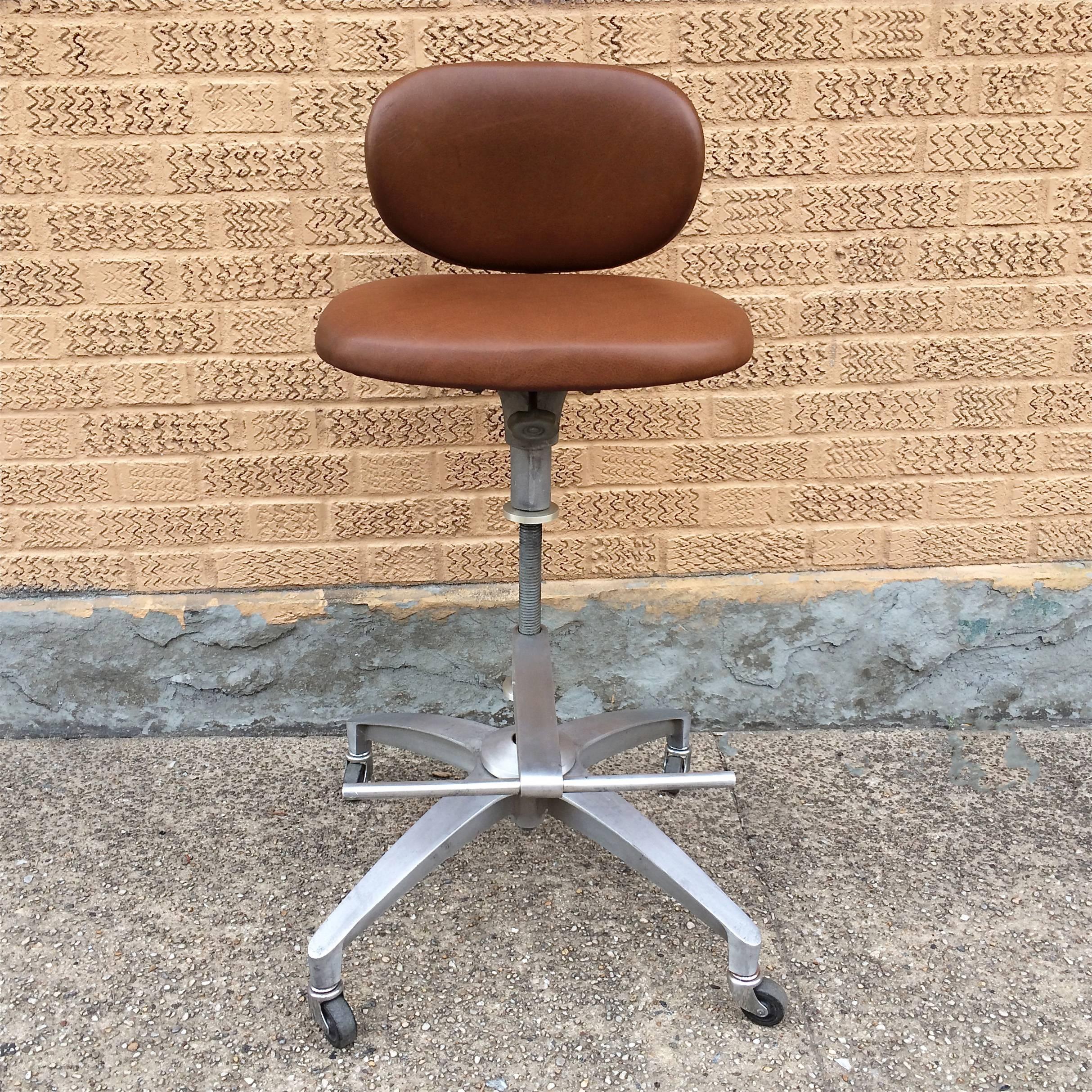 Mid-Century Modern, brushed aluminum, adjustable height, rolling, swivel, drafting stool with footrest by Shaw Walker with newly upholstered tan leather seat and back.
