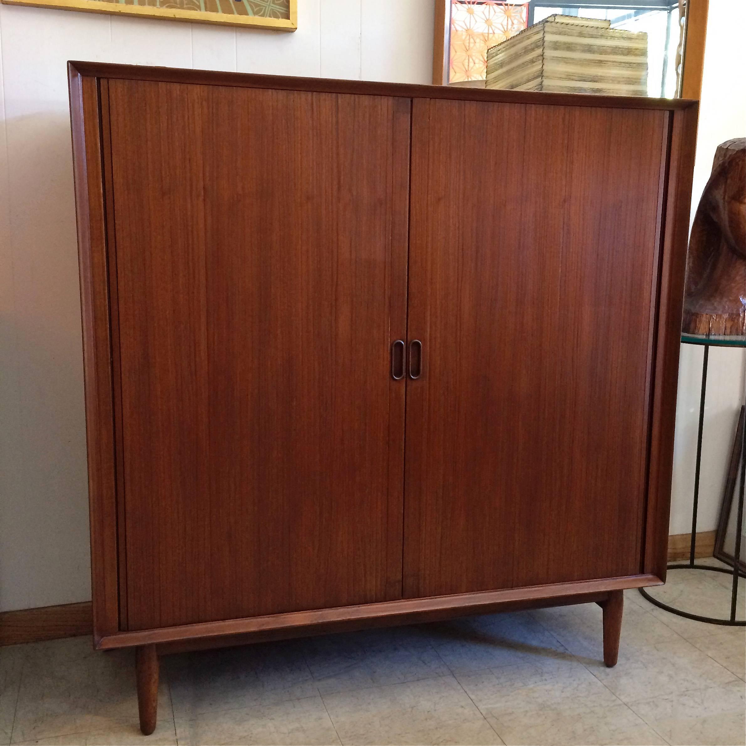 Danish modern, teak, gentlemen’s chest, highboy dresser by Arne Vodder for Sibast Mobler with tambour front doors and pull out shelves and drawers.
