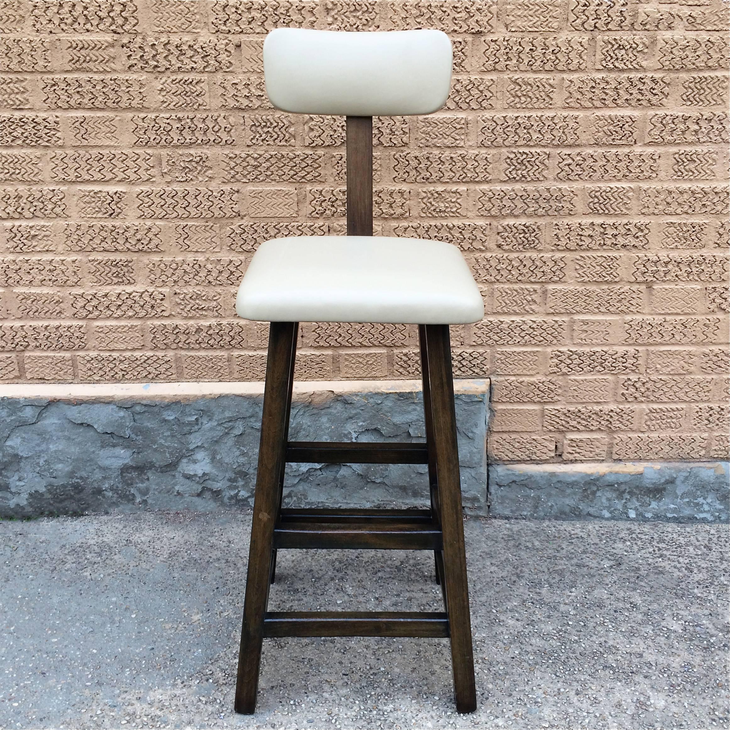 Single, tall, Arts & Crafts, shop stool features an ebonized maple frame with ecru leather seat and back circa 1930s. Backrest is height adjustable.