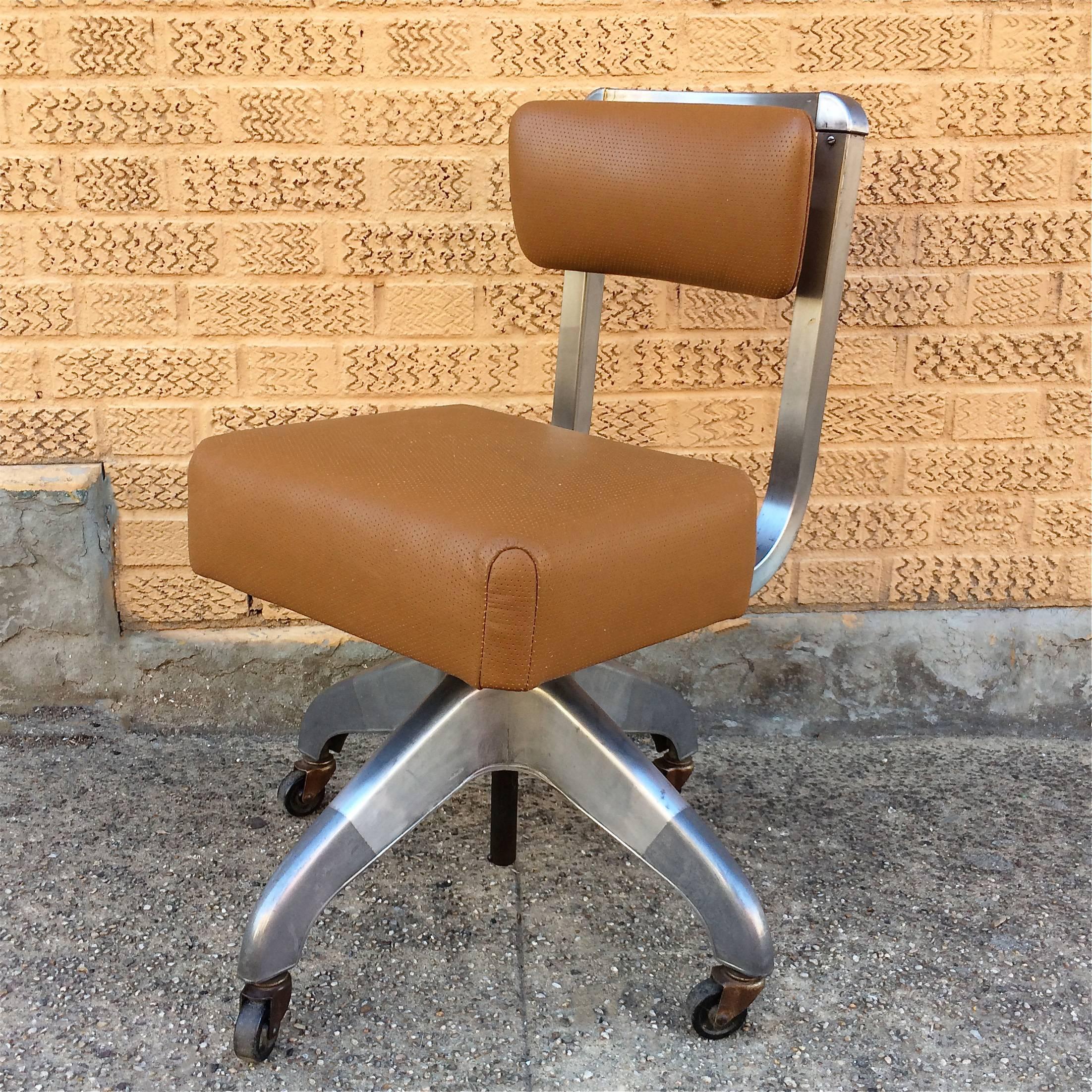 Mid-Century, rolling, adjustable height, office, desk chair with aluminium frame and newly upholstered perforated tan leather seat and back by DoMore Chair Company.