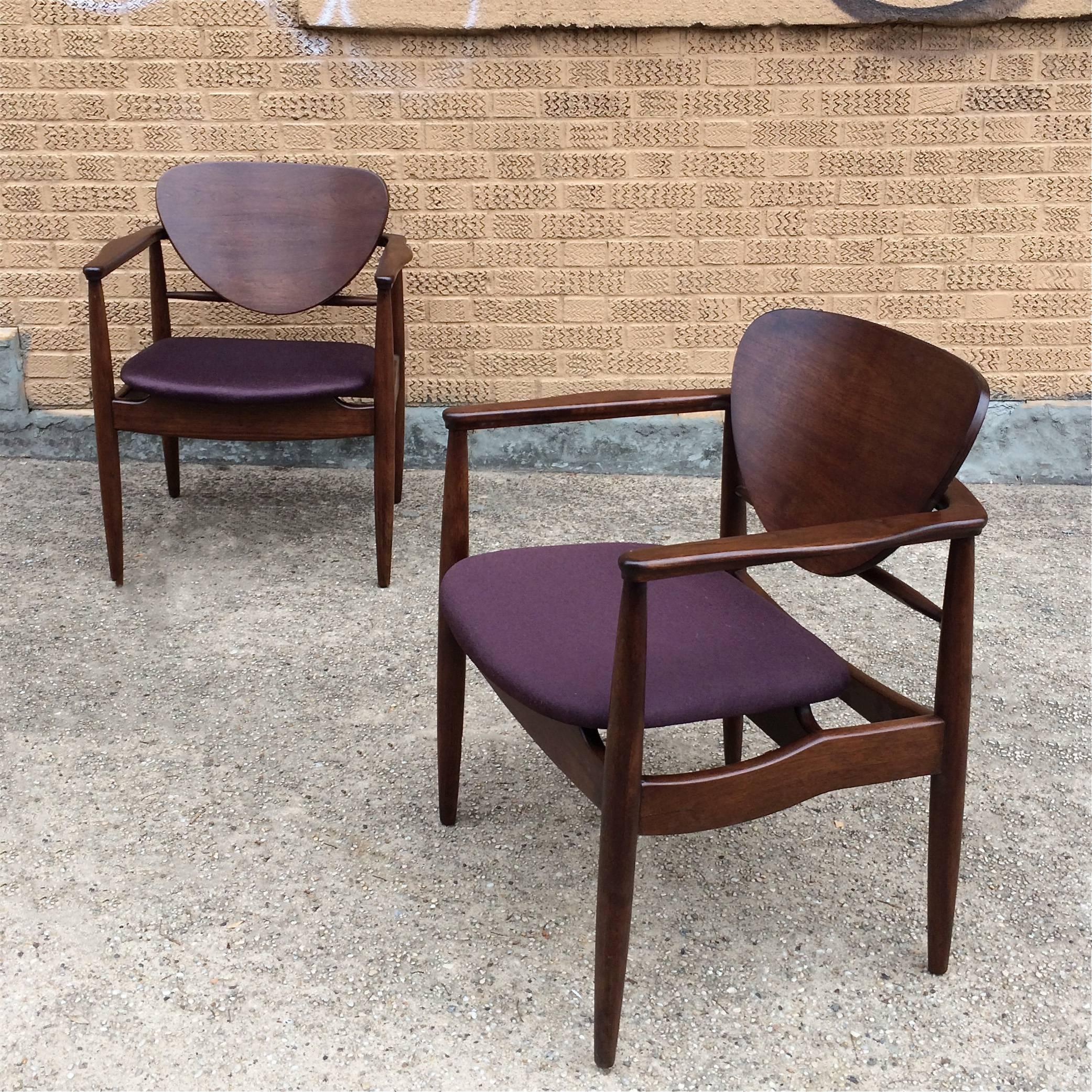 Pair of sculptural, walnut armchairs by Finn Juhl for John Stuart feature floating seats and backs upholstered in aubergine linen.