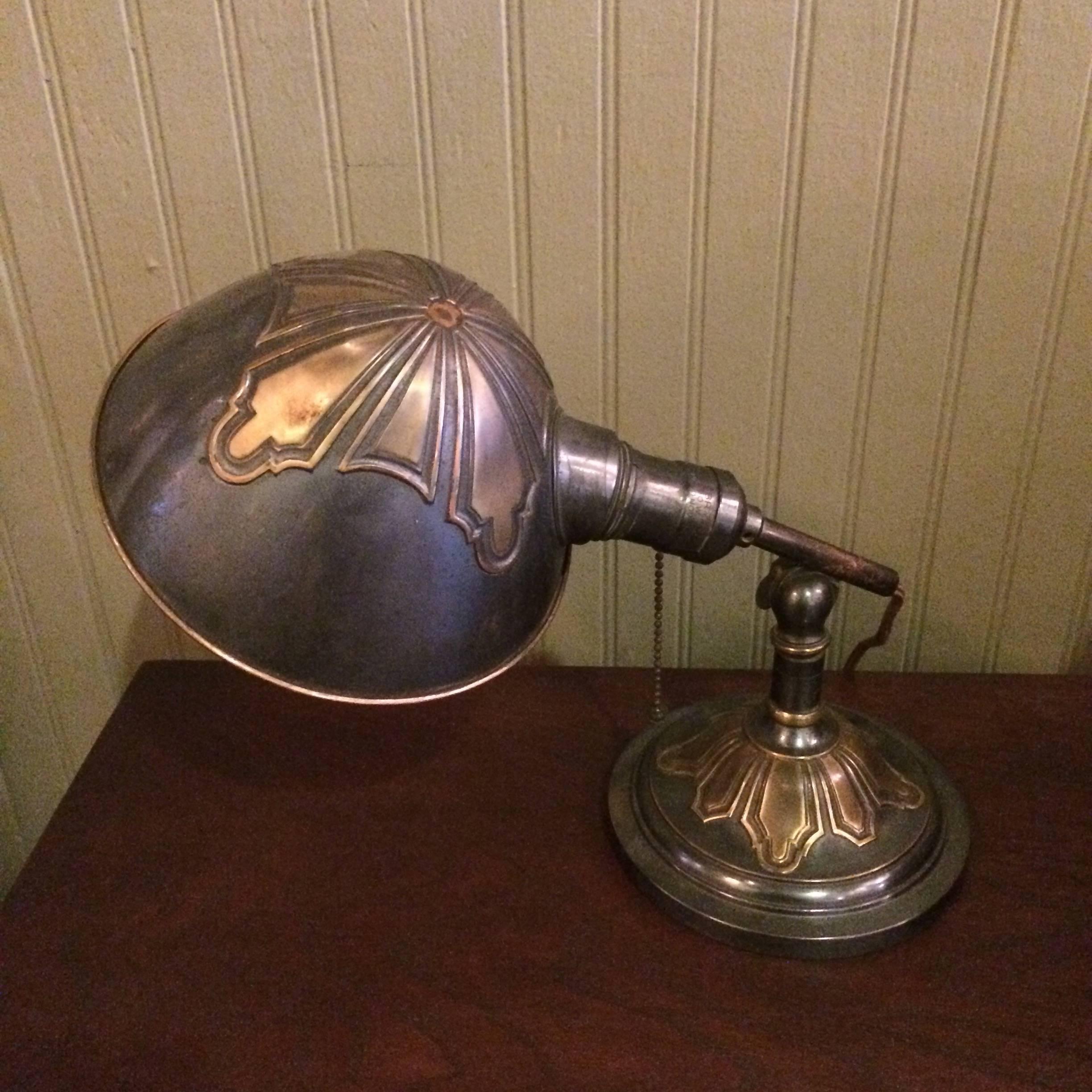 Arts & Crafts, articulating, copper, desk lamp with decoratively embossed base and shade with pull chain operation is newly wired with cloth cord.
