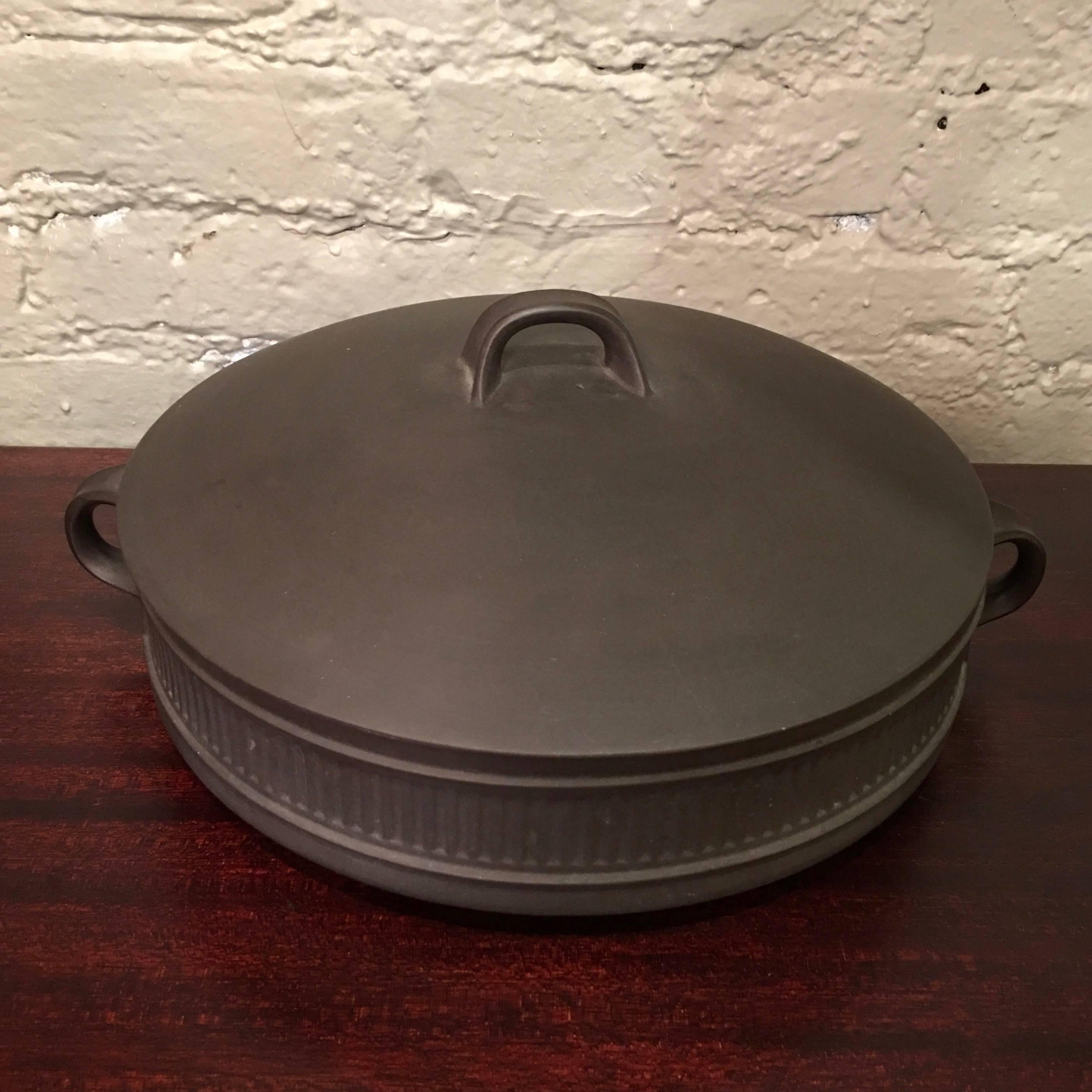 Danish modern, Flamestone cookware, casserole dish with cover by Jens Quistgaard for Dansk featuring a dark matte grey exterior with white glazed interior.