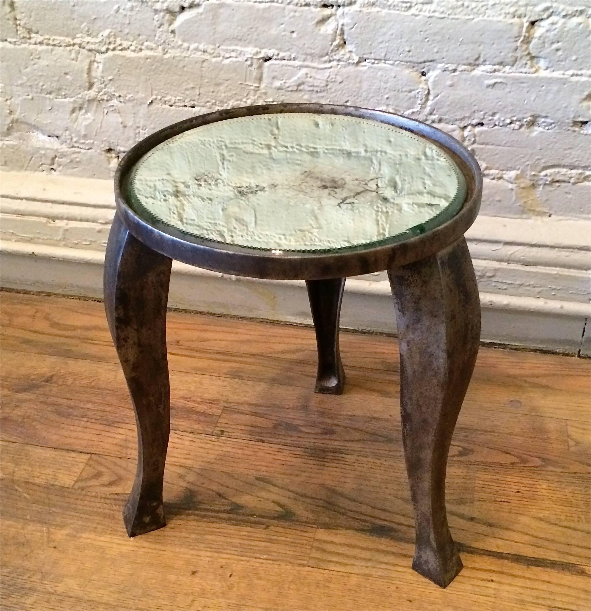 Industrial, cast iron base converted side table featuring distressed mirror top. The base surface shows traces of nickel-plating that captures a unique patina and is sealed to retain this current patina.