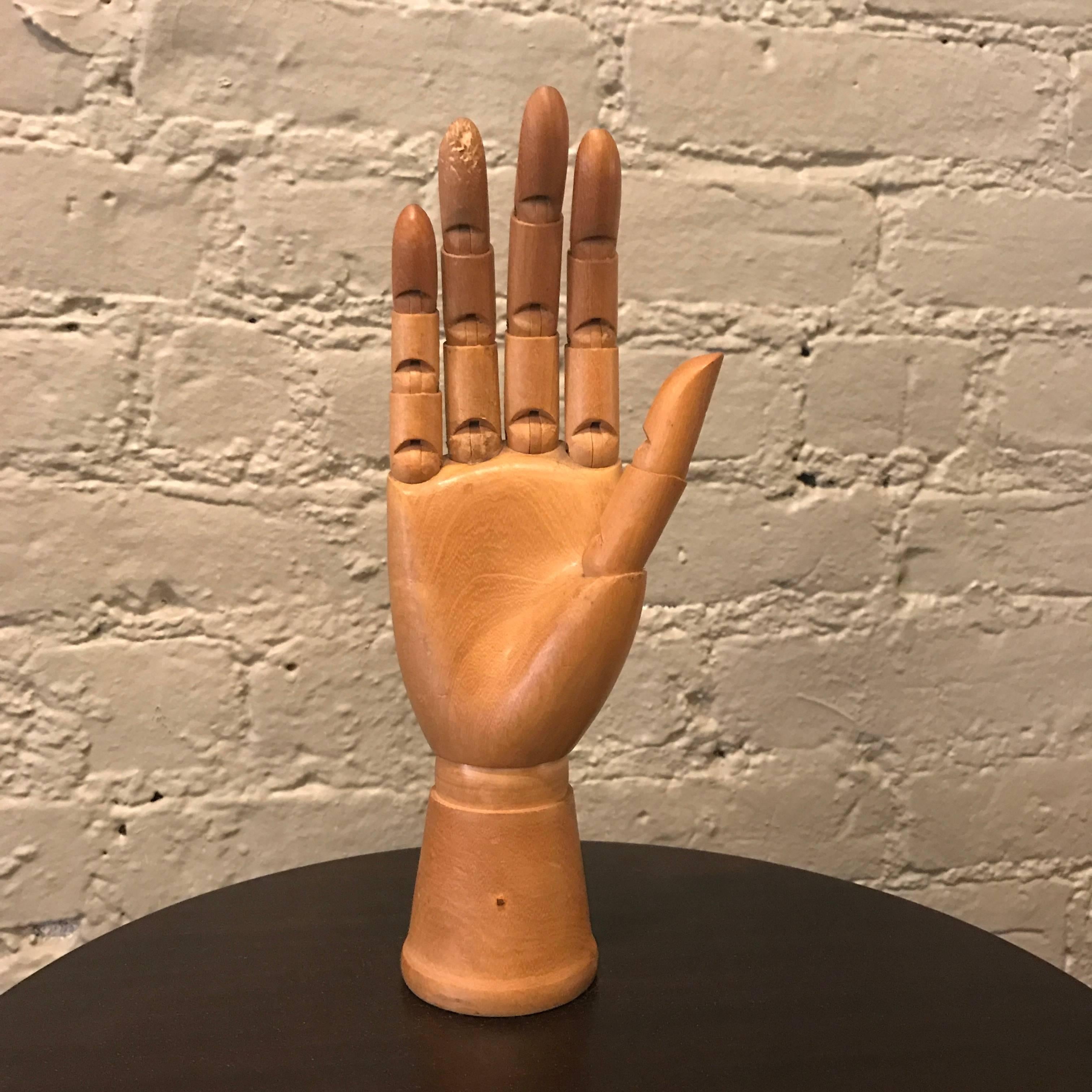 Articulating, maple, artist's hand model is fully articulated at each joint.