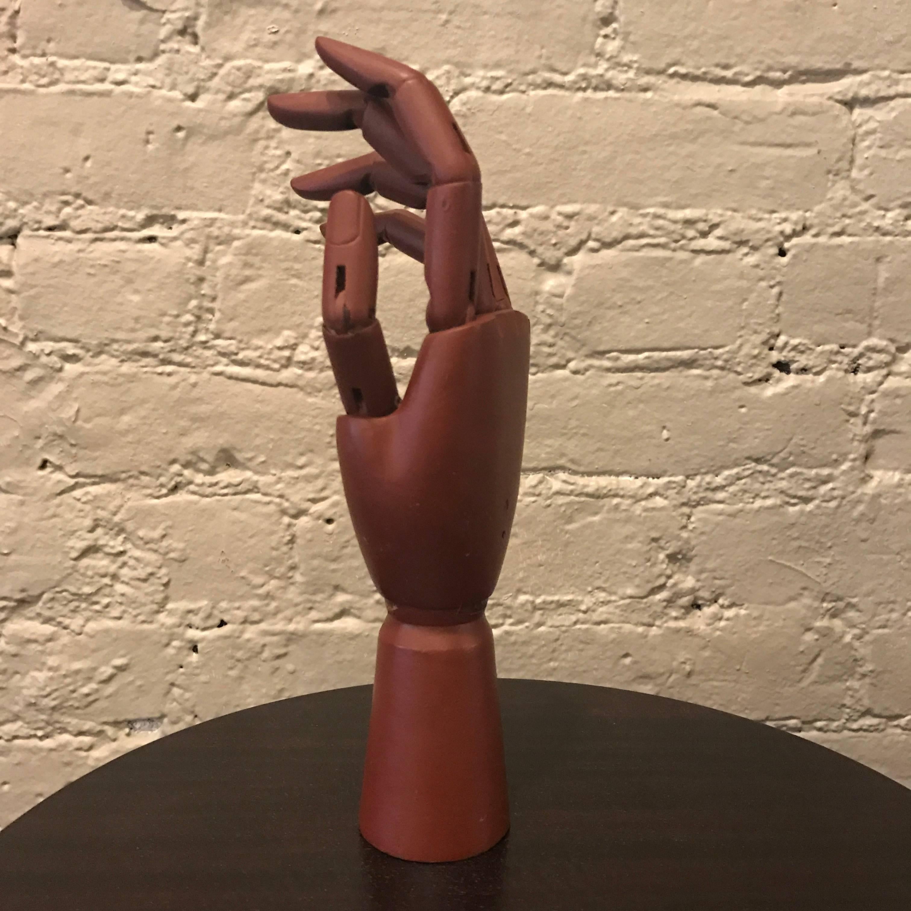 Articulating, mahogany, artist's hand model fully articulates at each joint.
