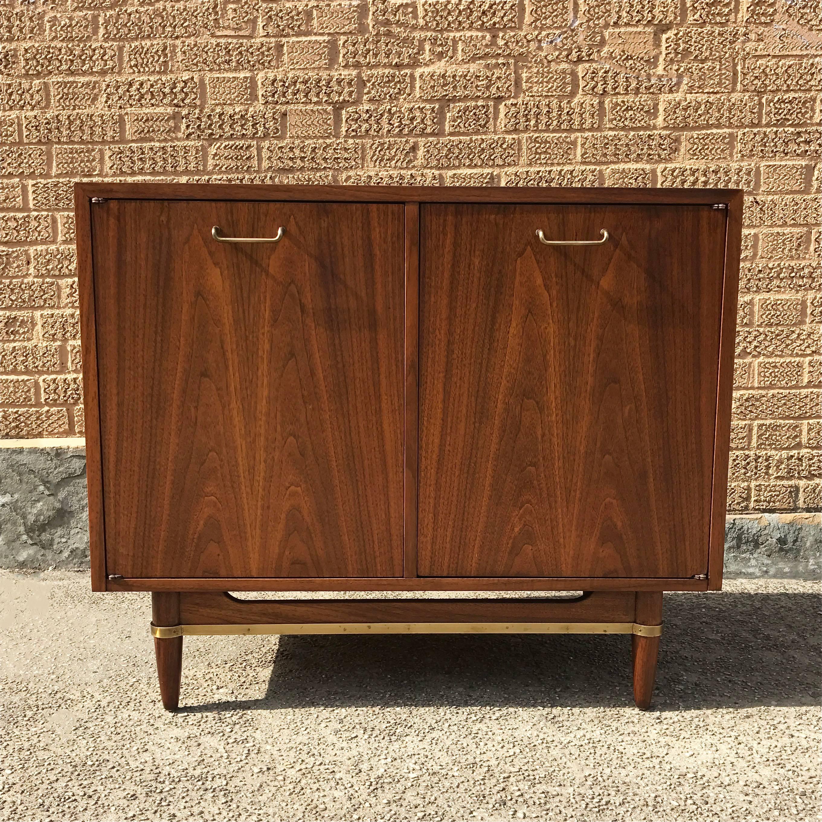 Mid-Century Modern, walnut dresser with brass accents by Merton Gershon for American’s of Martinsville also works well as a liquor or record cabinet or small sideboard.

  