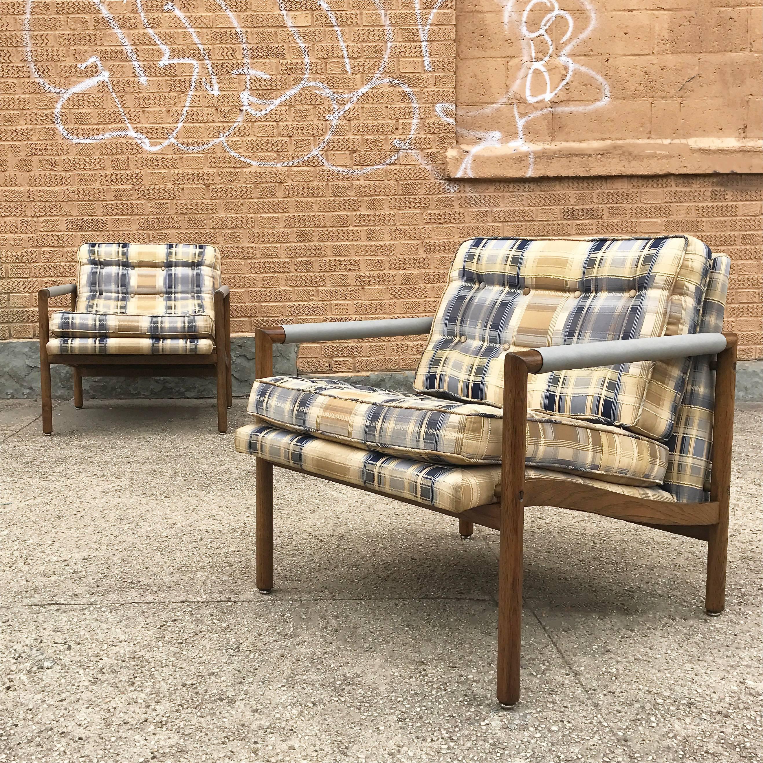 Pair of handsome, Mid-Century Modern, mahogany, club / lounge chairs feature semi attached cushions in their original plaid linen fabric in excellent condition and newly covered armrests in powder blue leather in the manner of Harvey Probber.