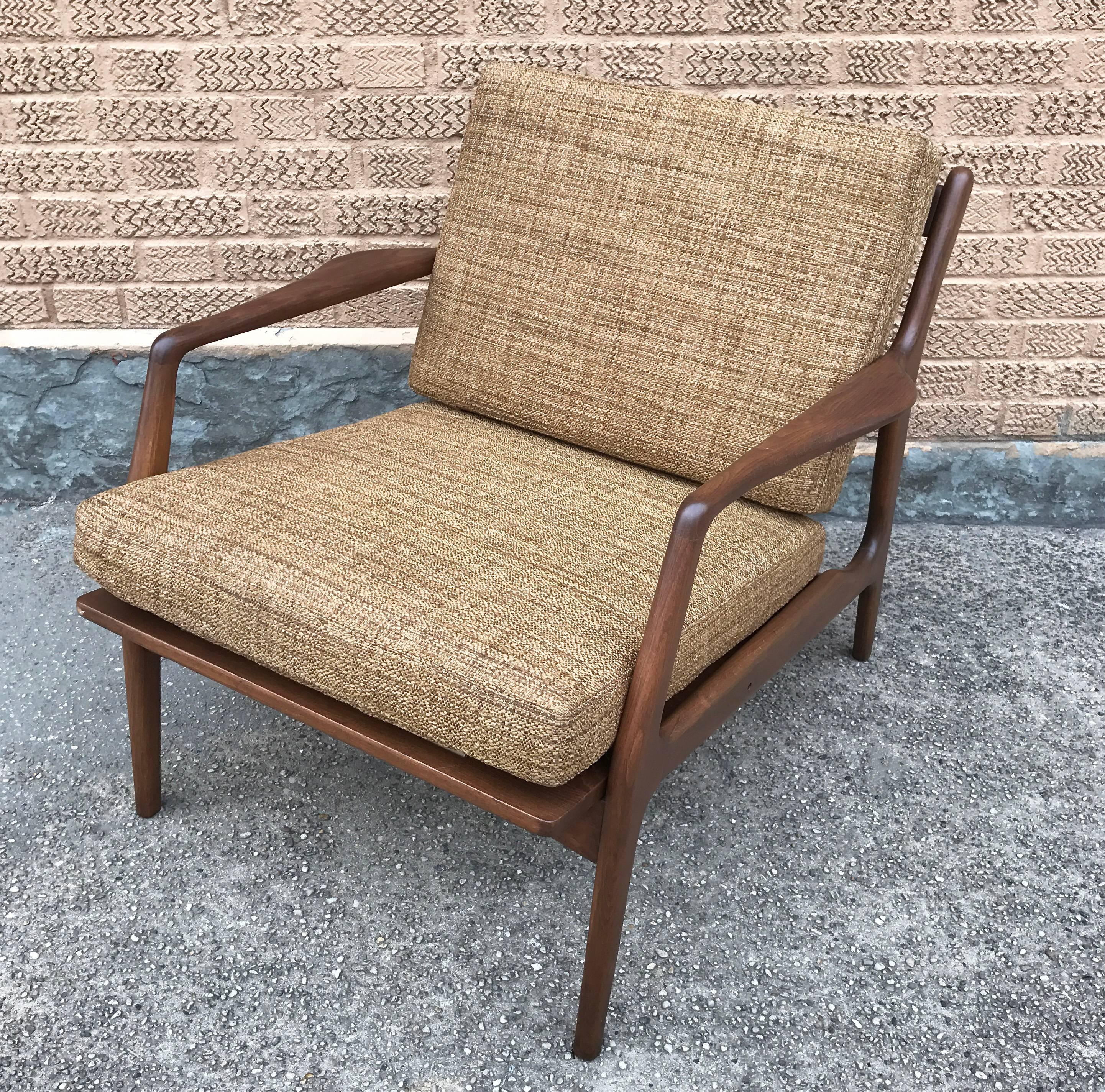 Handsome, Danish modern, lounge chair with sculptural, walnut frame by Ib Kofod-Larsen for Selig is newly restored with cushions upholstered in caramel tweed.
