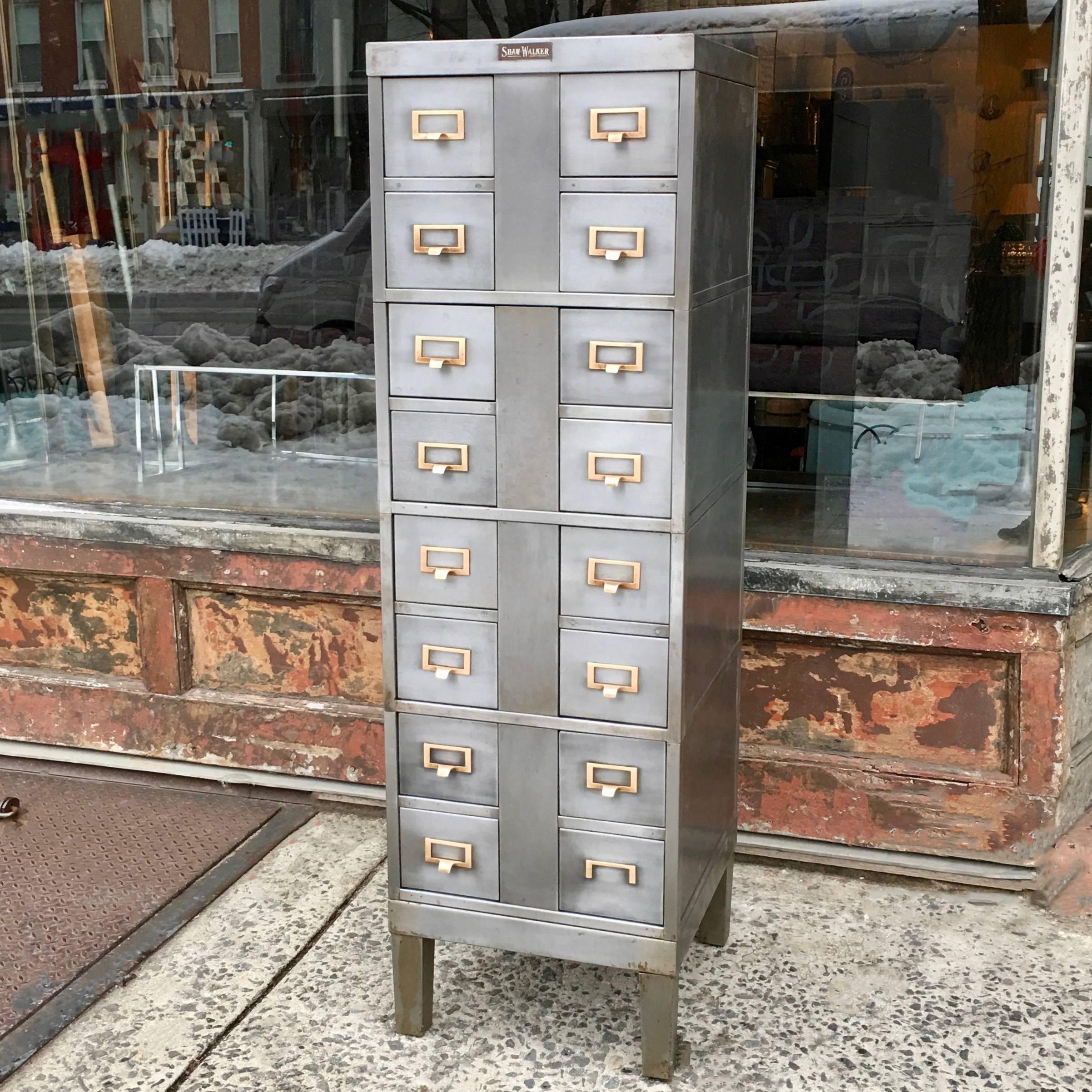 Industrial, Mid-Century, brushed steel office cabinet by Shaw Walker features four modular, interlocking cabinets with four index/card catalogue drawers that measure 6.25