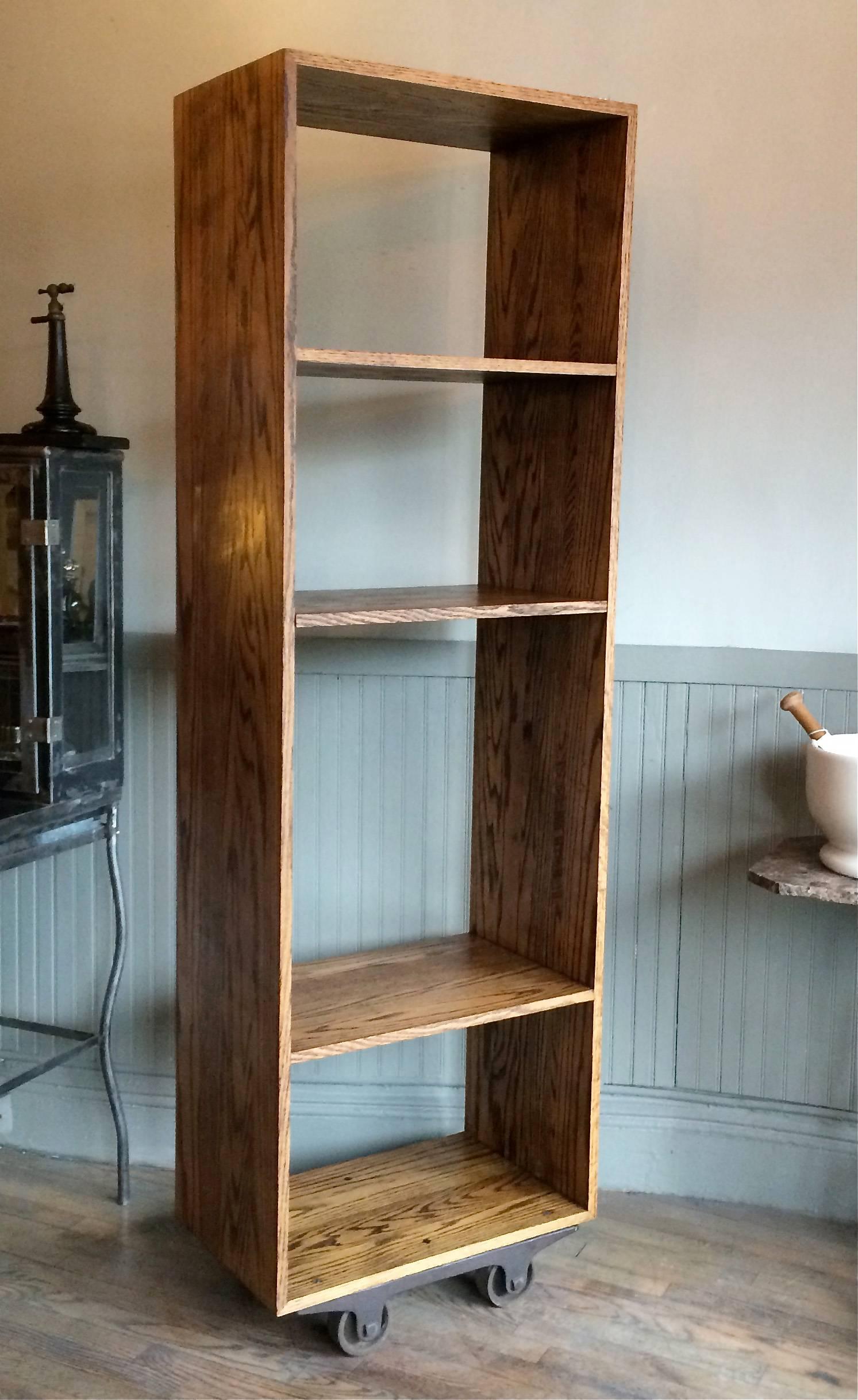 CF signature, solid ash, tall, open, industrial shelving unit, bookcase or display case features two adjustable middle shelves and rolls on antique casters is custom-made in Brooklyn by cityFoundry.