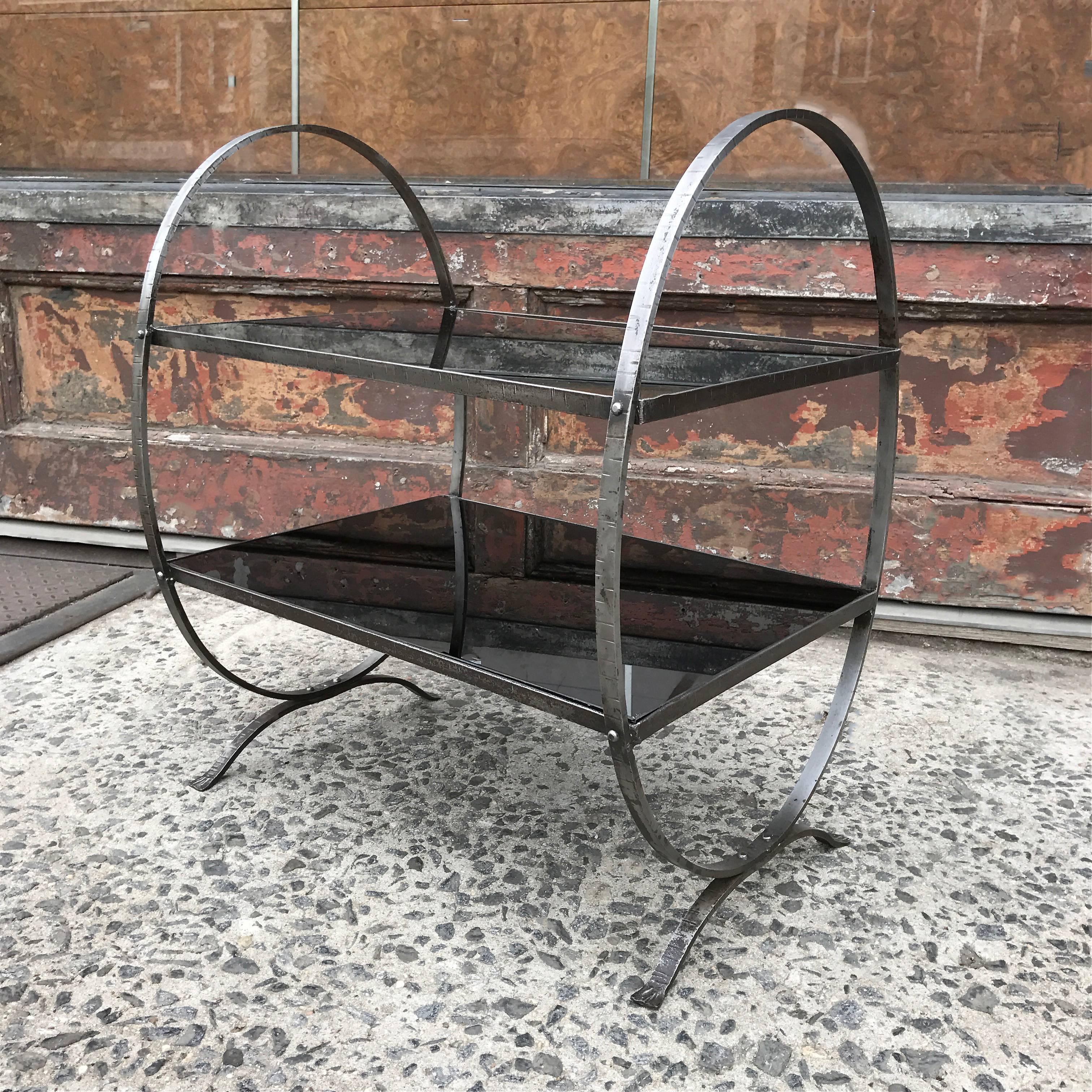 Art Deco, side table featuring looped, etched steel frame with two tiers of black glass; lower shelf is 10