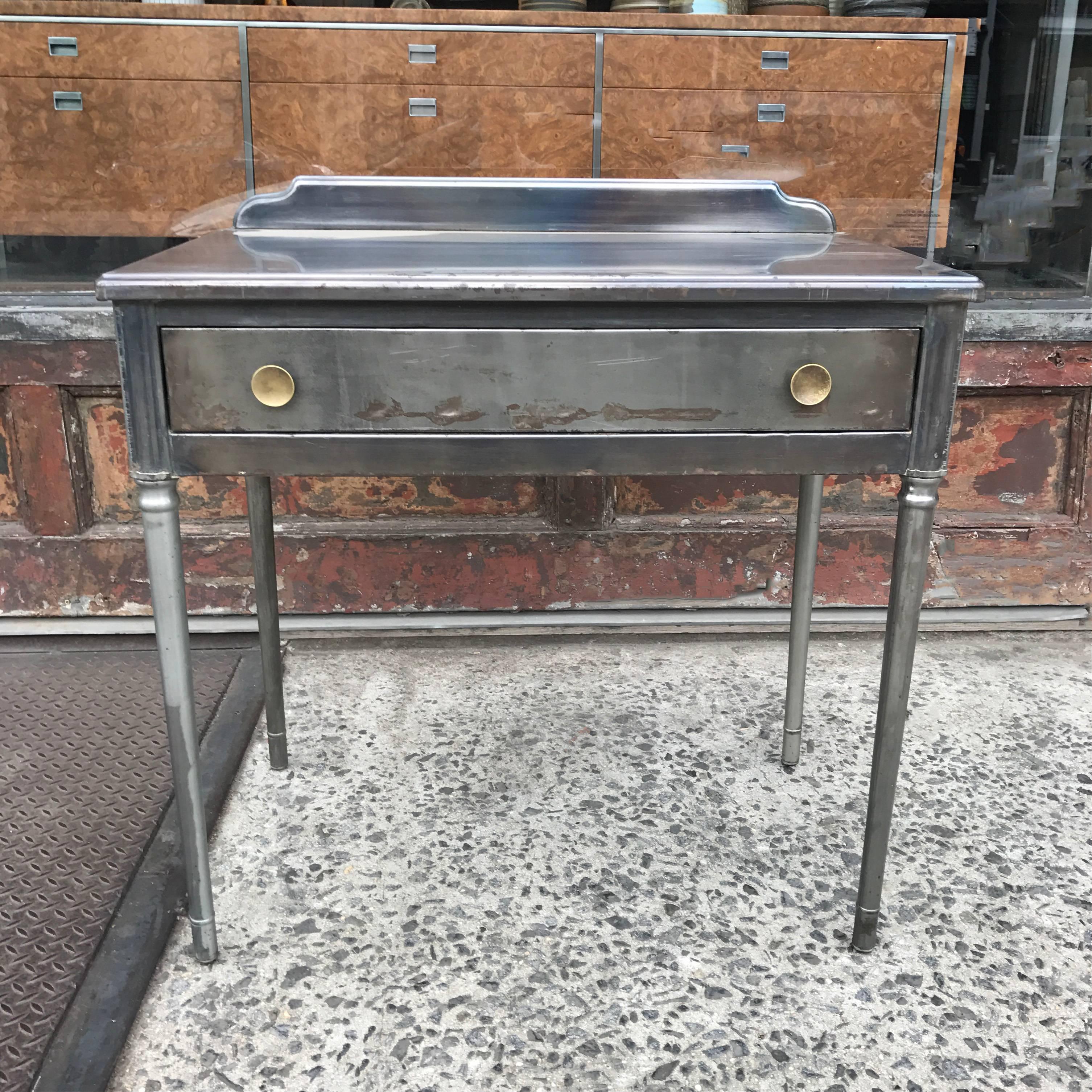 1930s, Industrial, pressed, brushed steel vanity or writing desk with brass pulls by Simmons Company Furniture Sheraton Series. Clearance to drawer is 23 in. height.