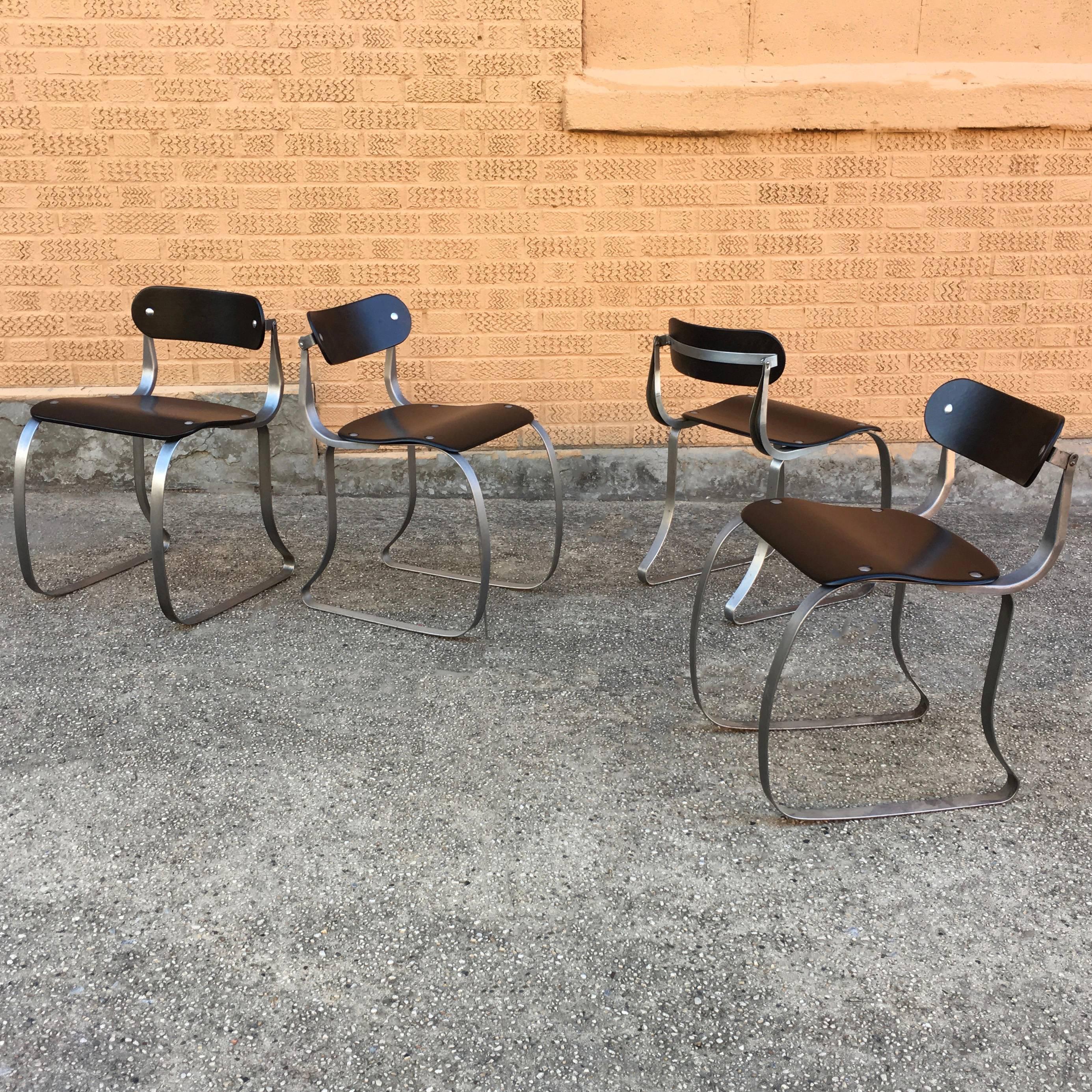 Set of four, Industrial, brushed steel and ebonized, bent maple plywood health chairs by Herman Sperlich for Ironrite Ironer company are newly finished and sealed.