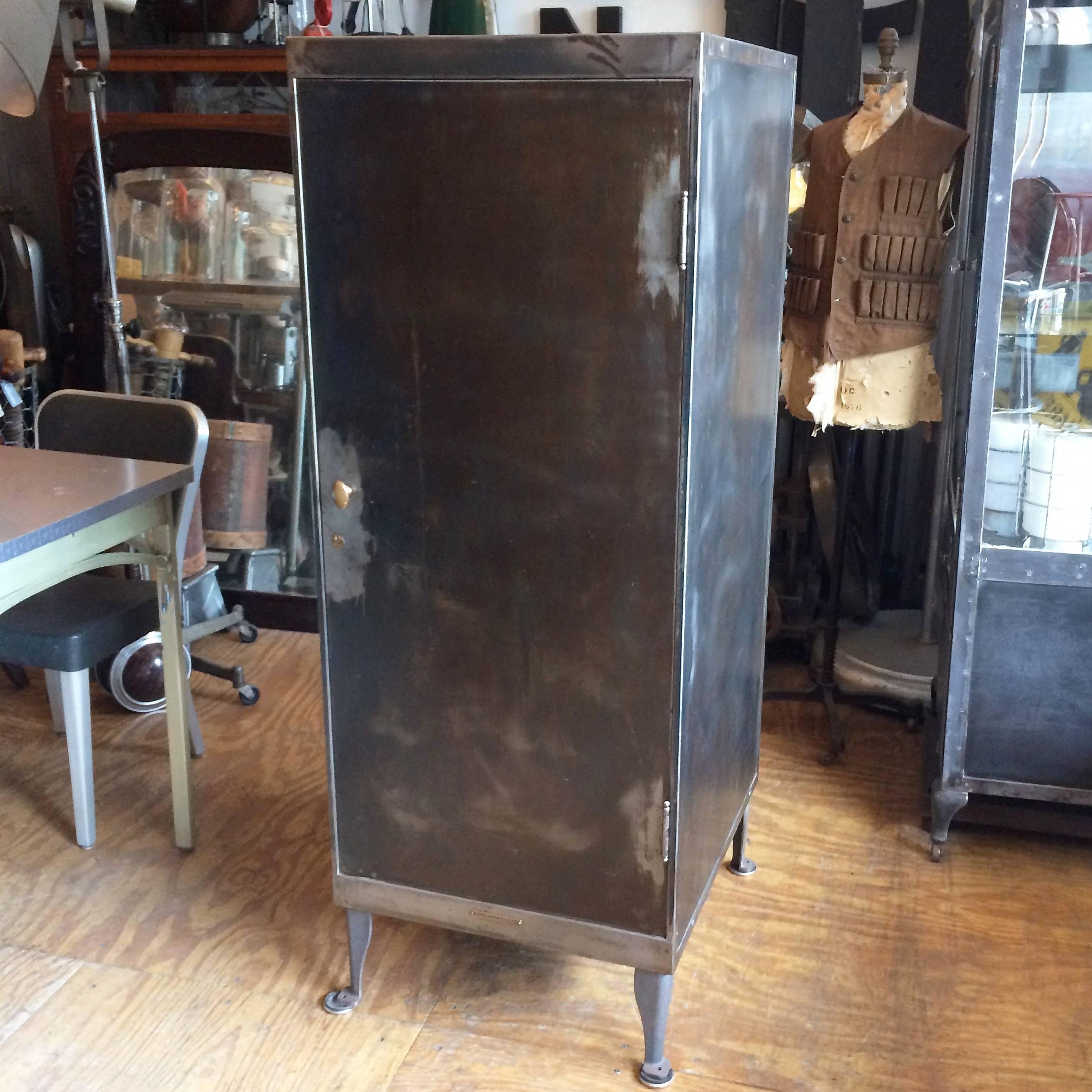 Industrial, brushed steel, office, document storage cabinet or safe by Library Bureau SoleMakers features brass accents with it's original brown interior with two adjustable shelves. The cabinet latches shut with the handle and there is a lock