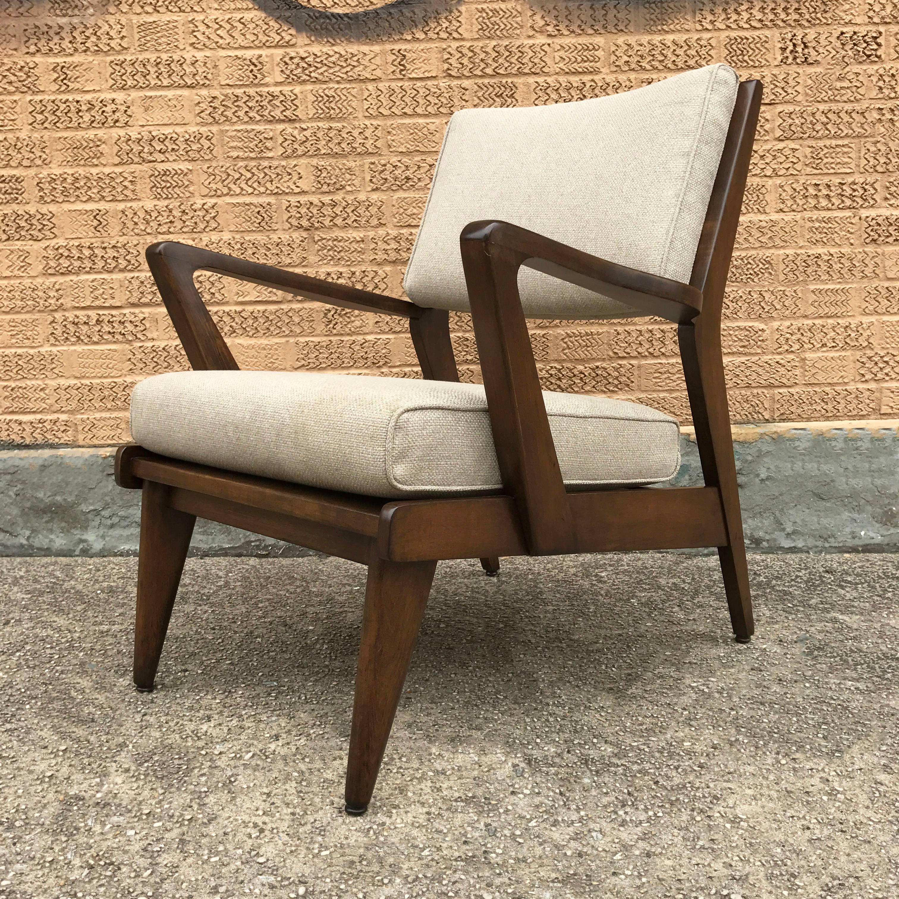 Mid-Century Modern, walnut armchair attributed to Jens Risom is newly upholstered in a cream linen blend.