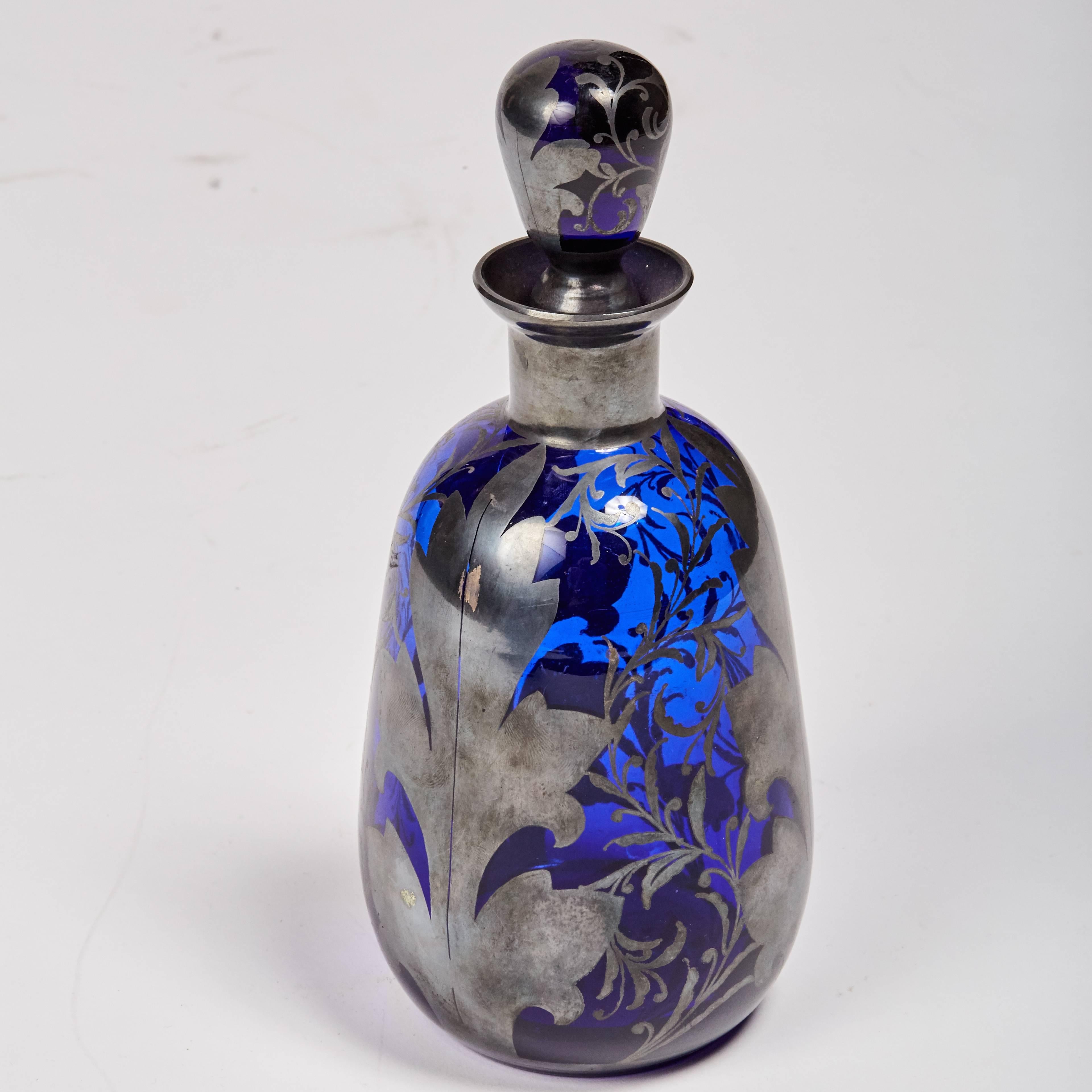 Midcentury, cobalt glass, decanter with stopper features hand-painted, sterling silver foliate details.