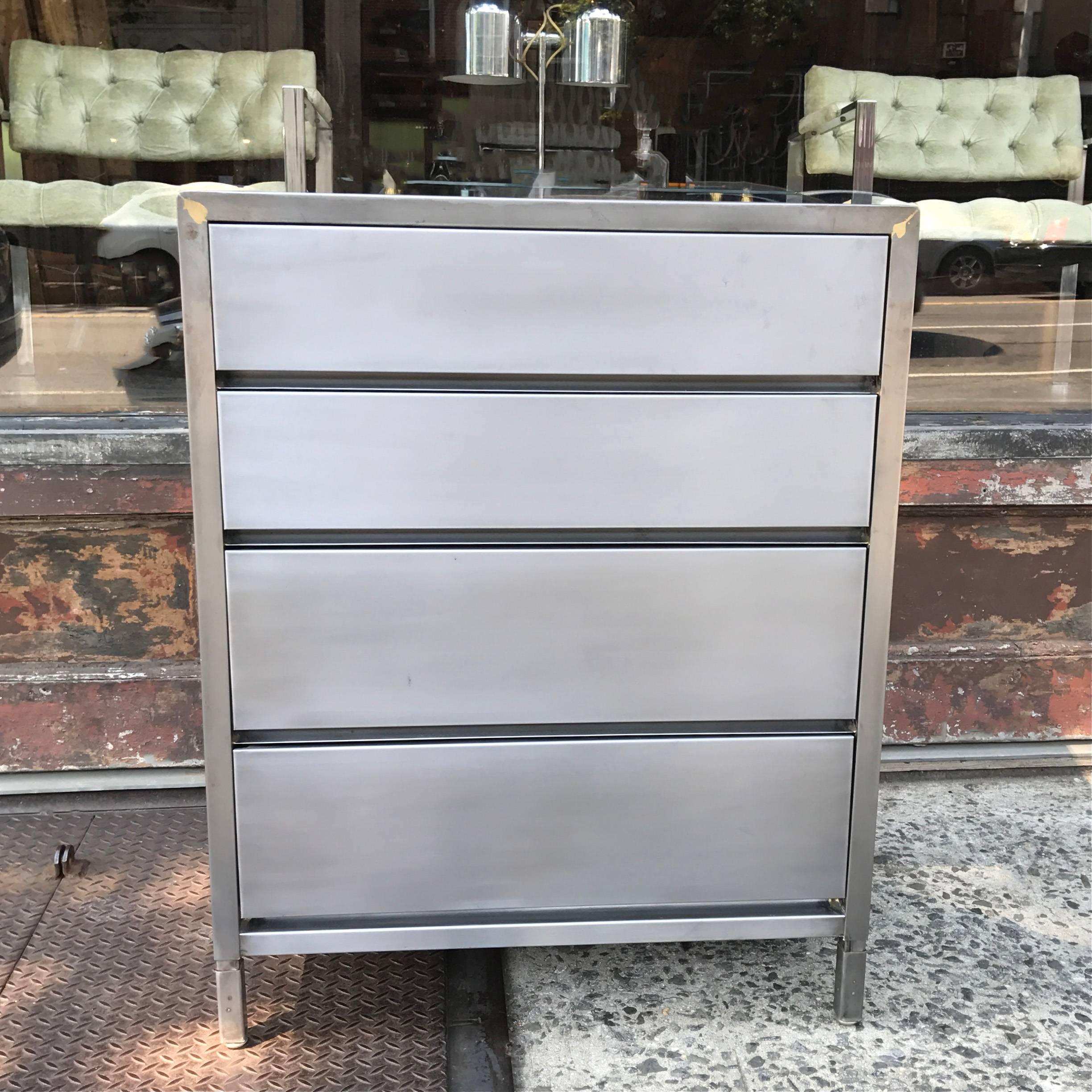 Mid-Century, machine age, industrial, brushed steel dresser by Superior Sleeprite Corp, Chicago, IL features four streamlined drawers.