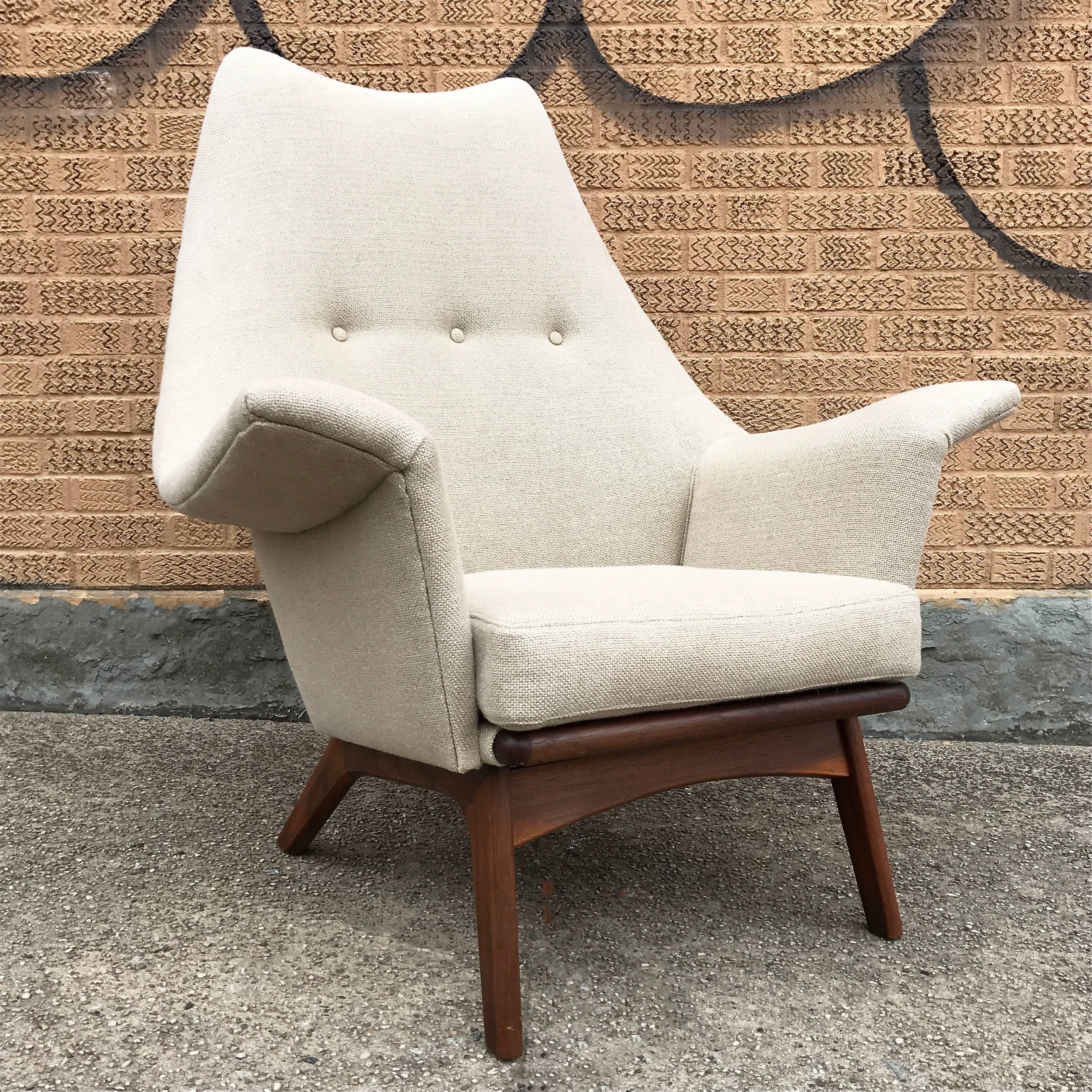 Sculptural Mid-Century Modern, 1960s, wingback, lounge chair designed by Adrian Pearsall is upholstered in a cream wool blend with a newly finished walnut base.