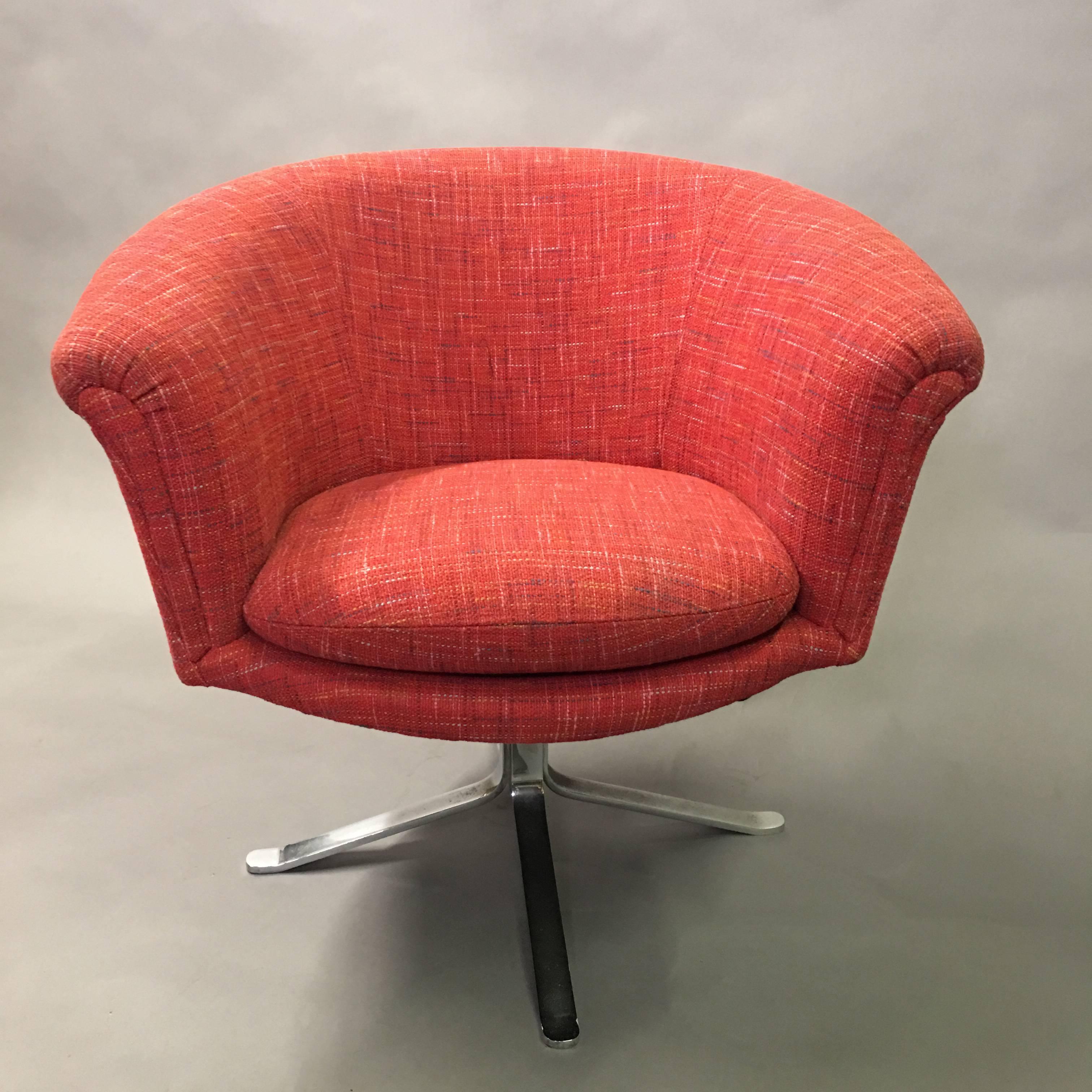 Mid-Century Modern, barrel shape armchair by Nicos Zographos is newly upholstered in a raspberry tweed blend and swivels on a four prong, flat bar, chrome pedestal base. The Gothic wrought iron coffee table shown is listed separately.